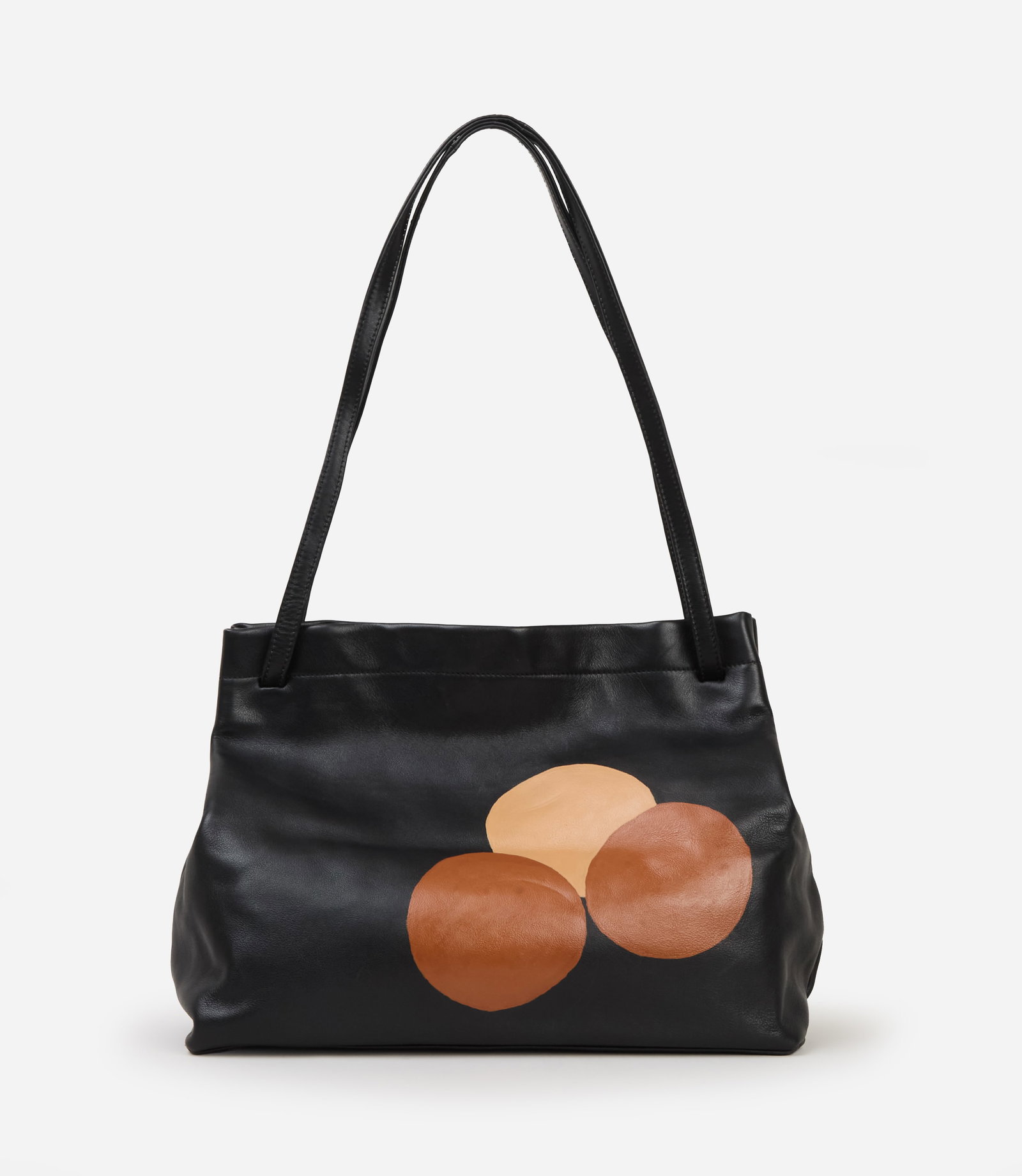 Barney's New York | 1990s Black Leather Handbag: Barney's New York 1990s Black Leather Handbag. The tote bag is designed with elongated shoulder straps and a softly structured rectangular body. The front panel features three overlapping circles in