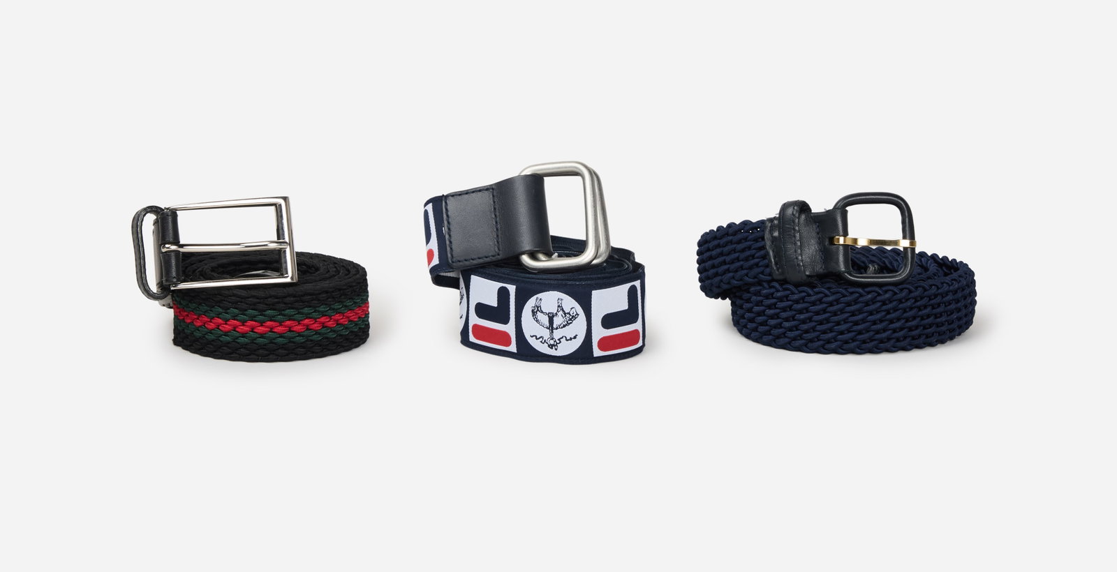 Designer Belts | Gucci, Charlotte belt, Fila: A group of three designer belts, one Gucci belt, one Charlotte belt and one Broks Brothers x FILA advantage reverible belt, from the collection of Cameron Silver. The black gucci elastic web belt