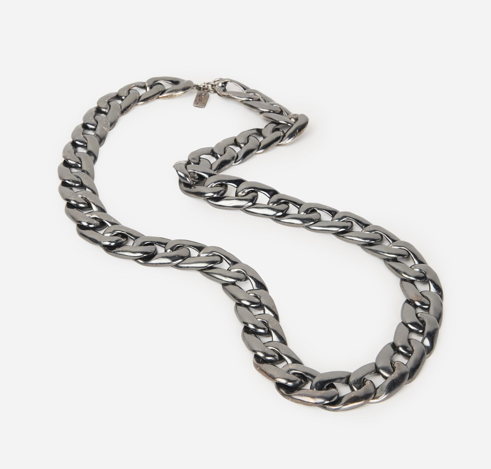 Yves Saint Laurent | Chrome Curb Chain Necklace: An Yves Saint Laurent chrome curb chain necklace with a YSL makers mark, country of origin is France. The length of the necklace measures 15.25 inches.