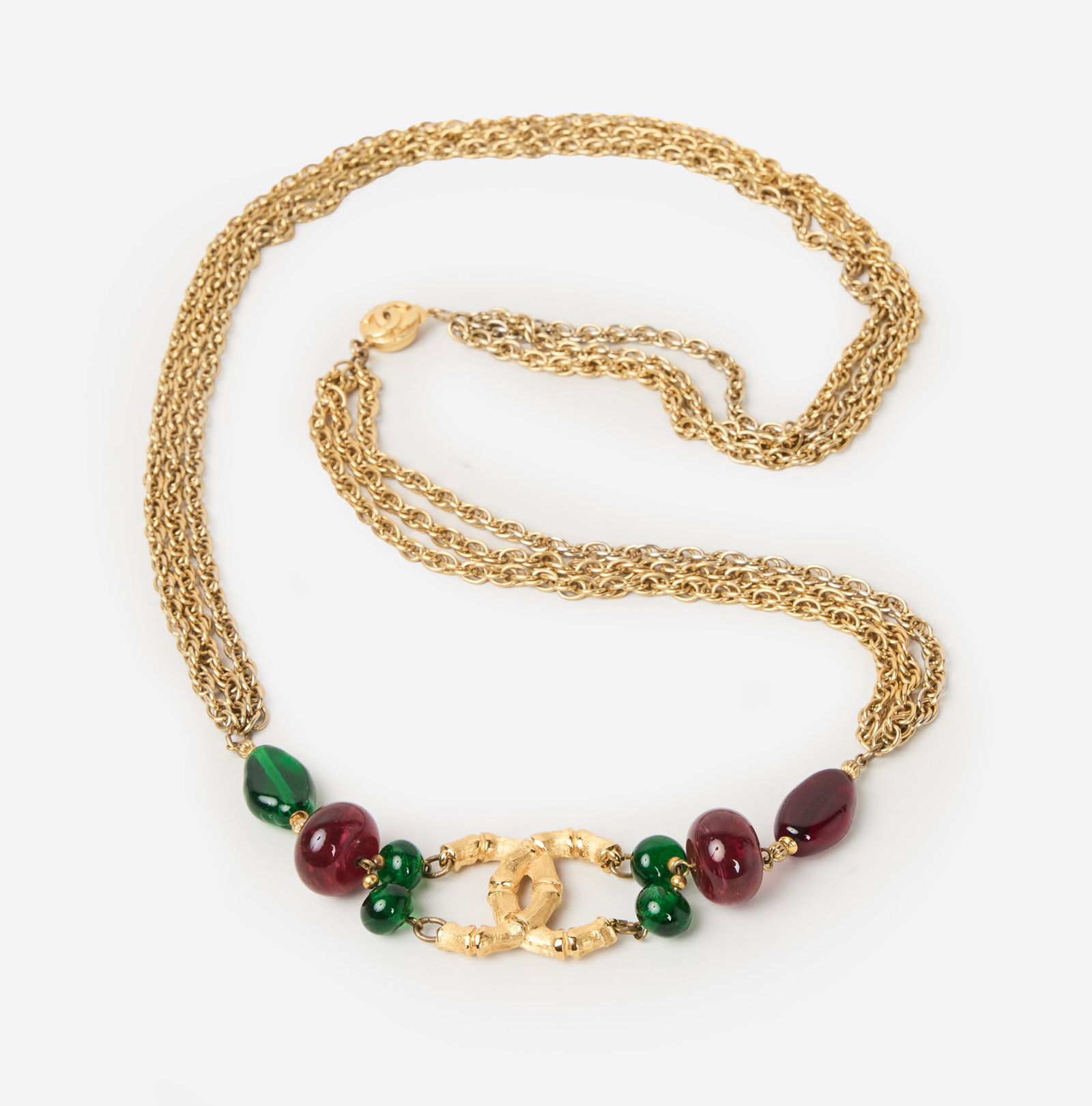 Chanel | 1980s Vintage Bamboo-Motif Three-Strand Chain Necklace: Chanel vintage necklace designed as a three-strand gold-tone chain necklace, accented at the front with a bamboo-motif double-C logo and further embellished with green and red glass beads. Measuring
