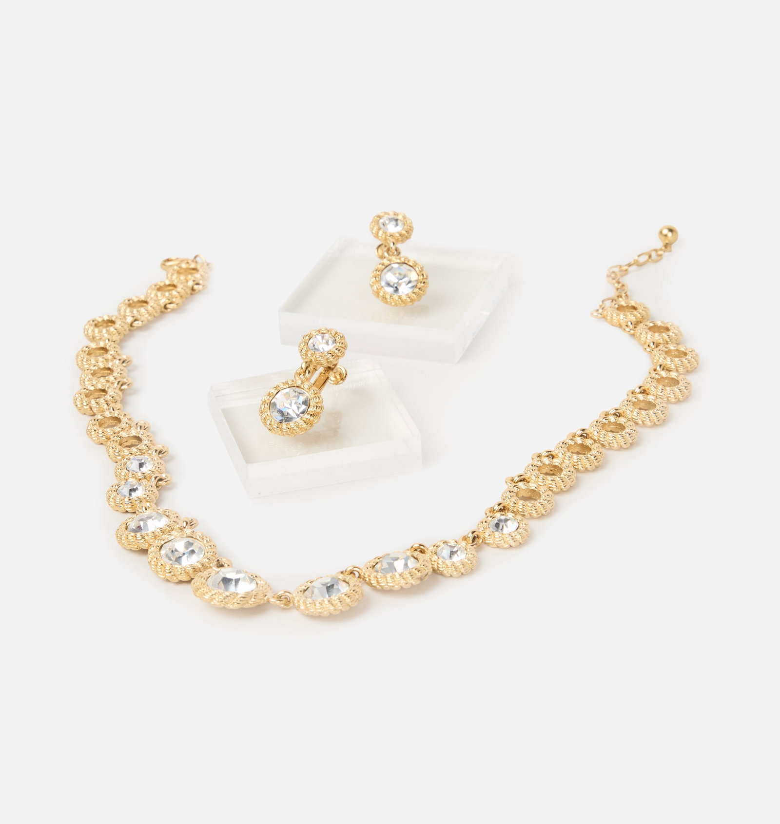 Jewelry | Gold Link Necklace with Matching Earrings: The necklace is composed of a series of textured circular gold-tone links, with the front accented by graduated rhinestones. Measuring 18 1/2 inches overall with an adjustable length. Accompanied by
