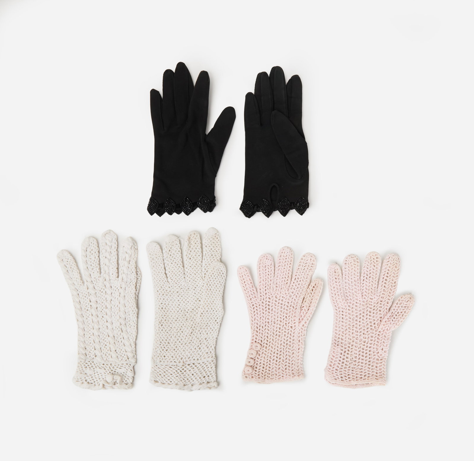 Ohrbach's | Three Pairs of Gloves: Three pairs of vintage gloves, one from the department store Ohrbach's. The black gloves are composed of cotton and trimmed with black beads and velvet. Labeled size 6? and made in Hong Kong. Also