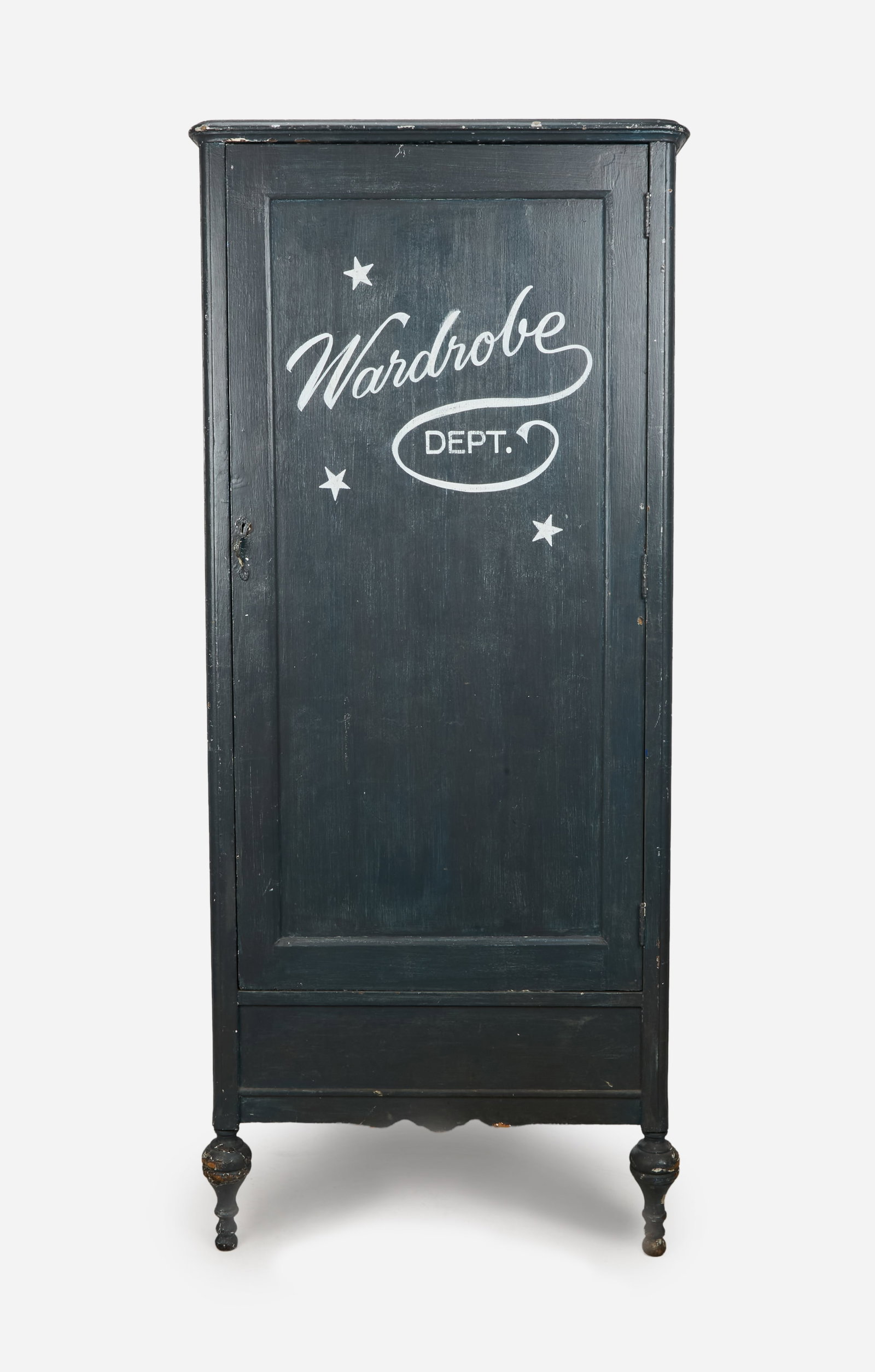 Disney | Vintage "Wardrobe Dept." Distressed Blue Wood Armoire: A vintage wood armoire wardrobe cabinet with a distressed state blue-painted exterior and white lettering reading "Wardrobe Dept.," the single left-opening door with a painted metal handle. the case