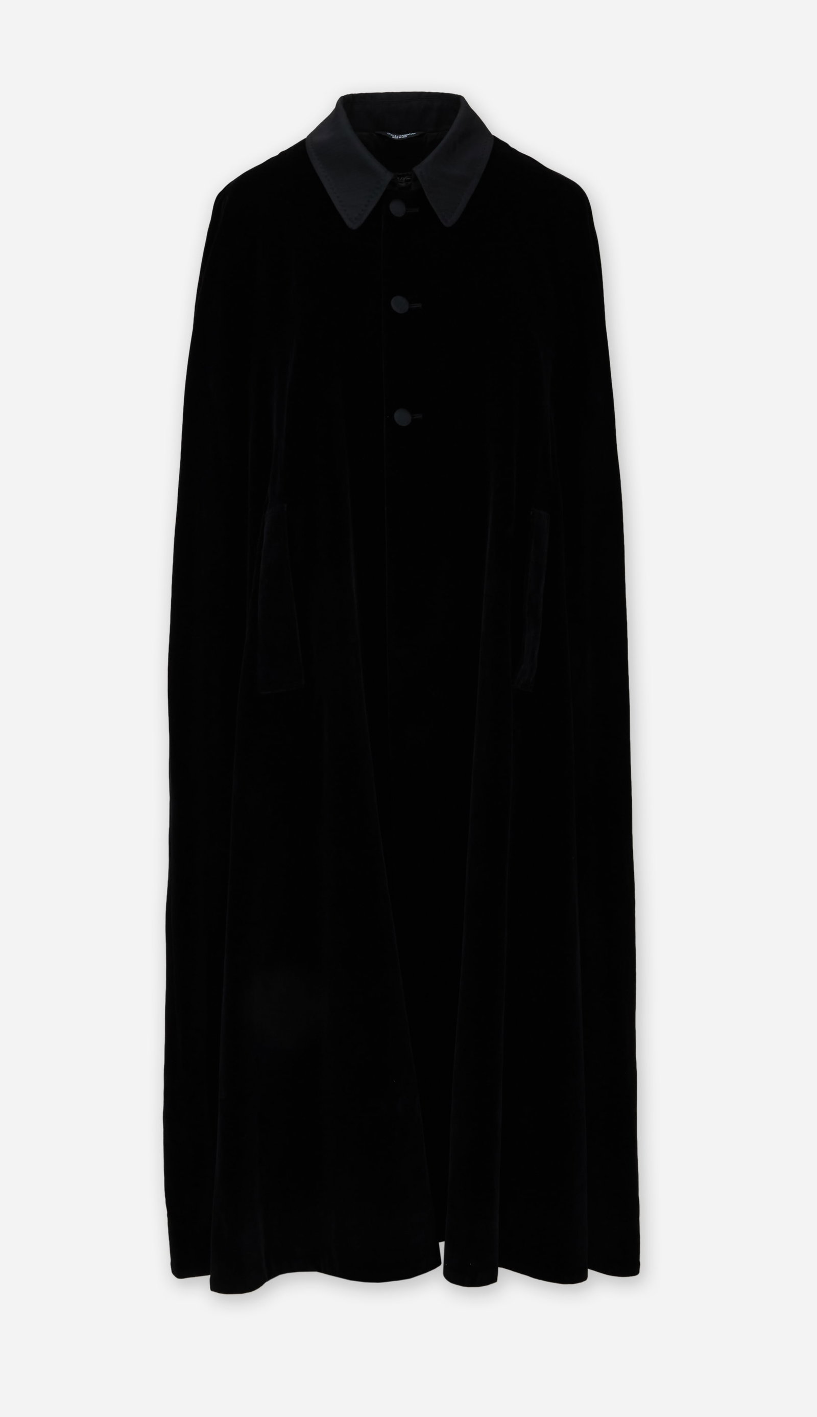 Dolce & Gabbana | Black Mid-Length Cape: Dolce & Gabbana black velvet mid-length cape from the collection of Cameron Silver. The cape is composed of 90% cotton and 10% viscose and features a silk faille collar, a three-button front closure,
