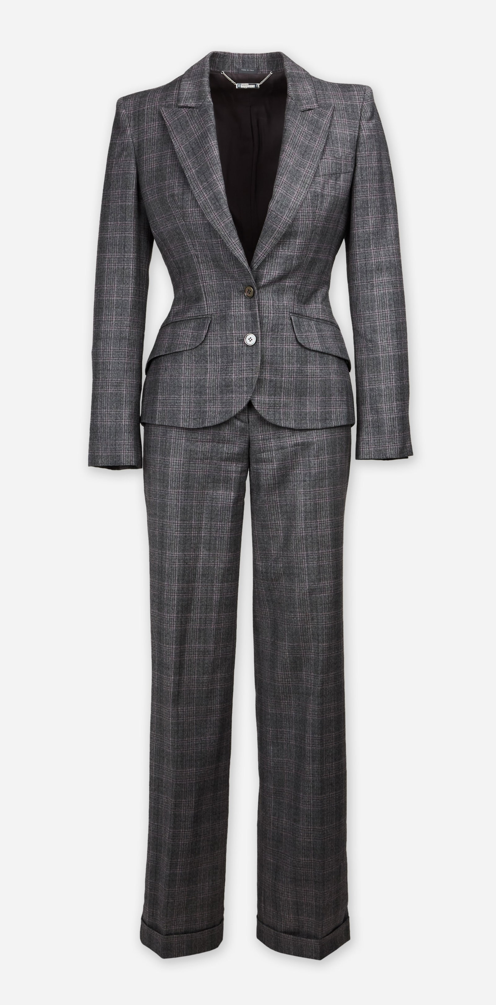 Alexander McQueen | 2009 Prince of Wales Check Suit: Alexander McQueen two-piece Prince of Wales check suit designed during Lee McQueen's lifetime dated 2009. The suit features a single-breasted jacket peak lapel padded shoulders asymmetric hem with a