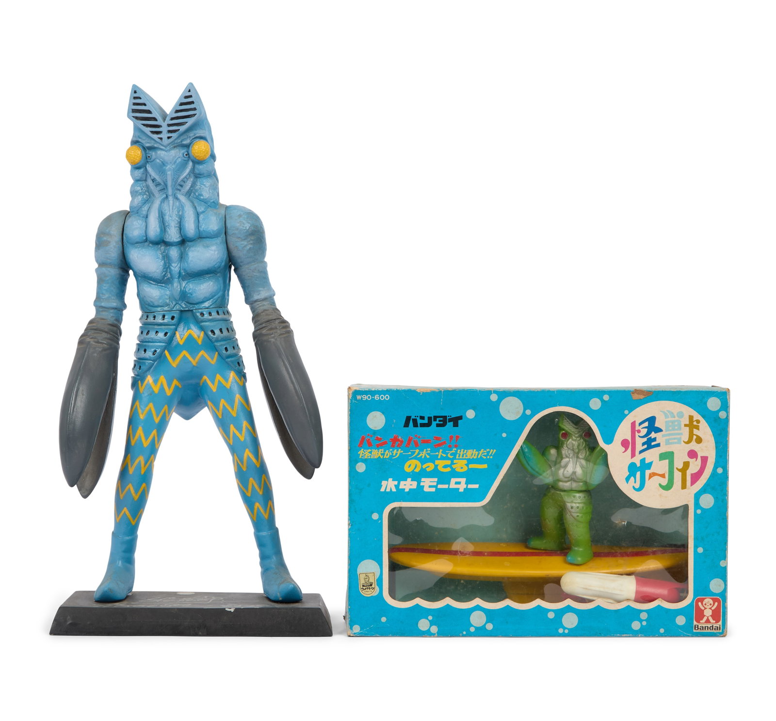 Ultraman | Alien Baltan Figurine Signed by Sompote Sands with Additional Figurine: A sofubi Alien Baltan figurine mounted to a black stand. The stand features the signature of filmmaker Sompote Sands in silver-tone marker. Together with a vintage Alien Baltan Surfing Kaiju figure