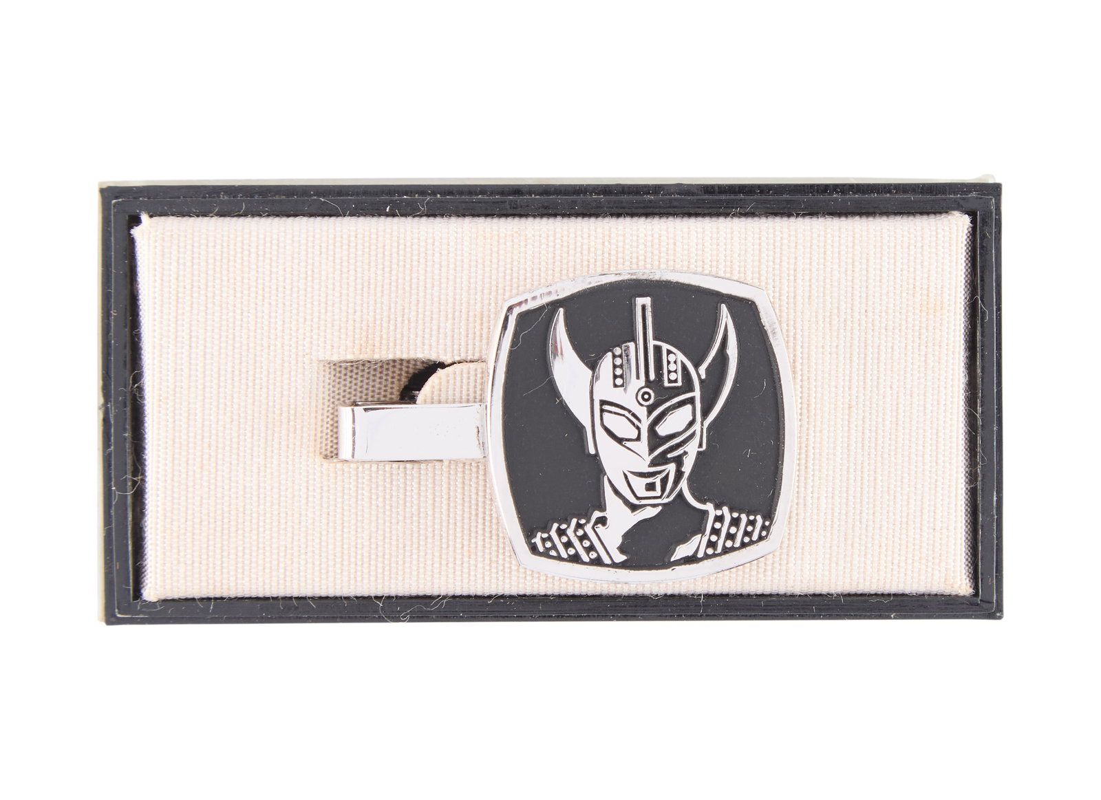 Ultraman Taro | Tie Clip: A metallic, clip-on, tie clip featuring a carved image of Ultraman Taro. Accompanied by a small display/carrying case. From the Estate of Sompote Sands