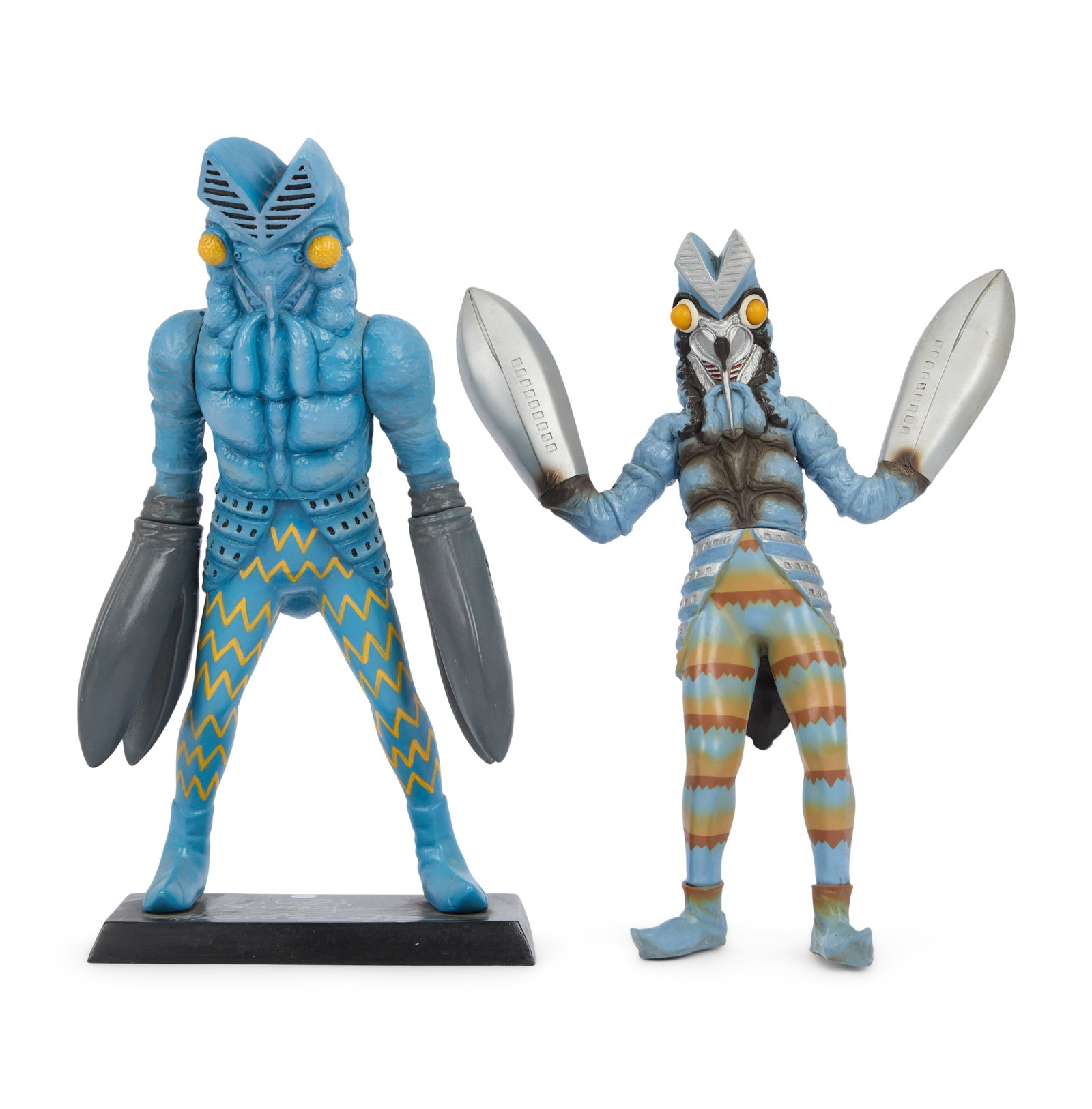 Ultraman | Alien Baltan Figurine Signed by Sompote Sands with Additional Figurine: A sofubi Alien Baltan figurine mounted to a black stand. The stand features the signature of filmmaker Sompote Sands in silver-tone marker. Together with an additional Alien Baltan Sofubi figure.