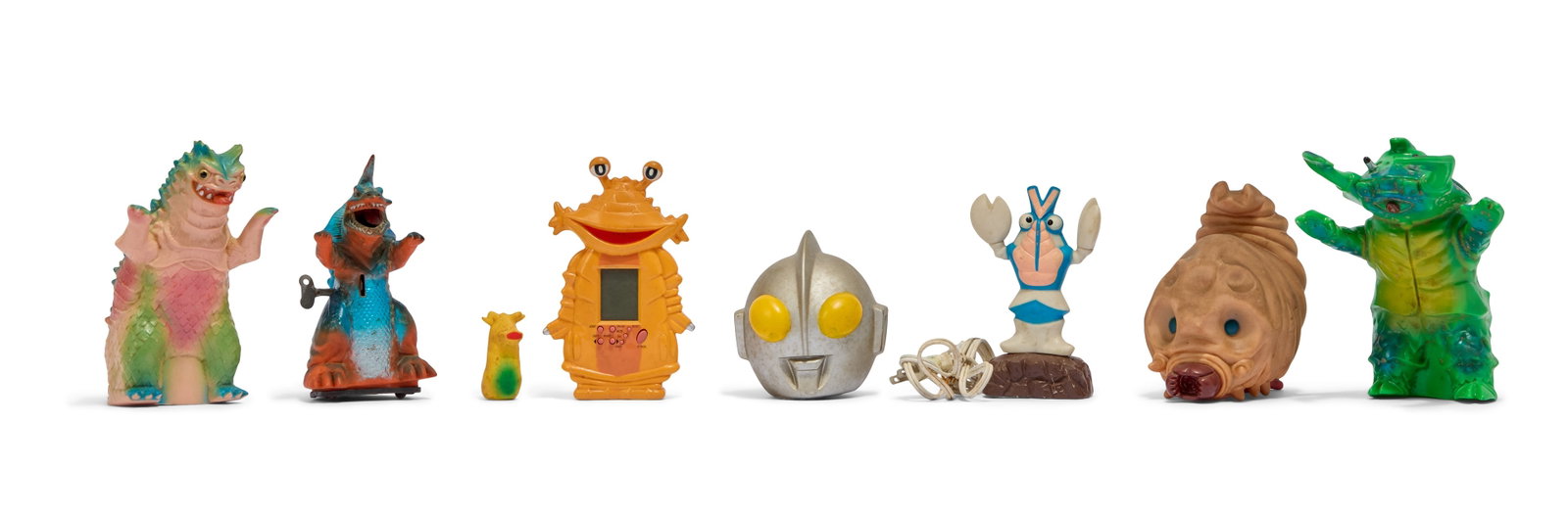 Ultraman | Vintage Novelty Toys (8): A collection of seven novelty toys relating to various characters from the Ultraman franchise. Includes: -Ultraman Helmet Coin Bank -2002 Billiken Antlar Sofubi Hand Puppet -2000 Billiken