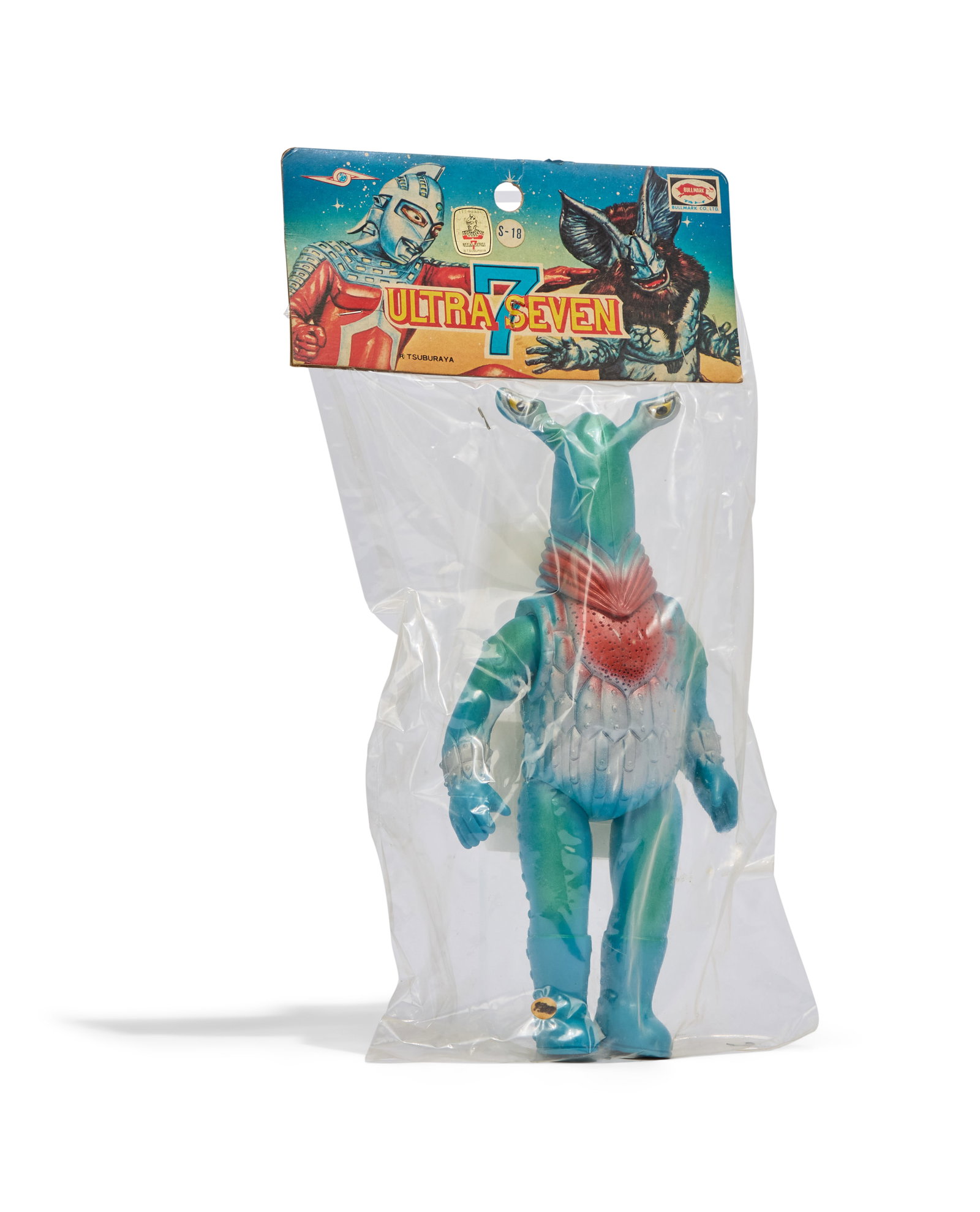 Sofubi | Vintage Alien Pegassa Hawaiian Figure with Original Packaging: A vintage Bullmark Alien Pegassa Hawaiian figure with its original packaging, including header and plastic. The header includes the I.T.I Hawaii Ultraseven Tsuburaya authentication sticker. Damage
