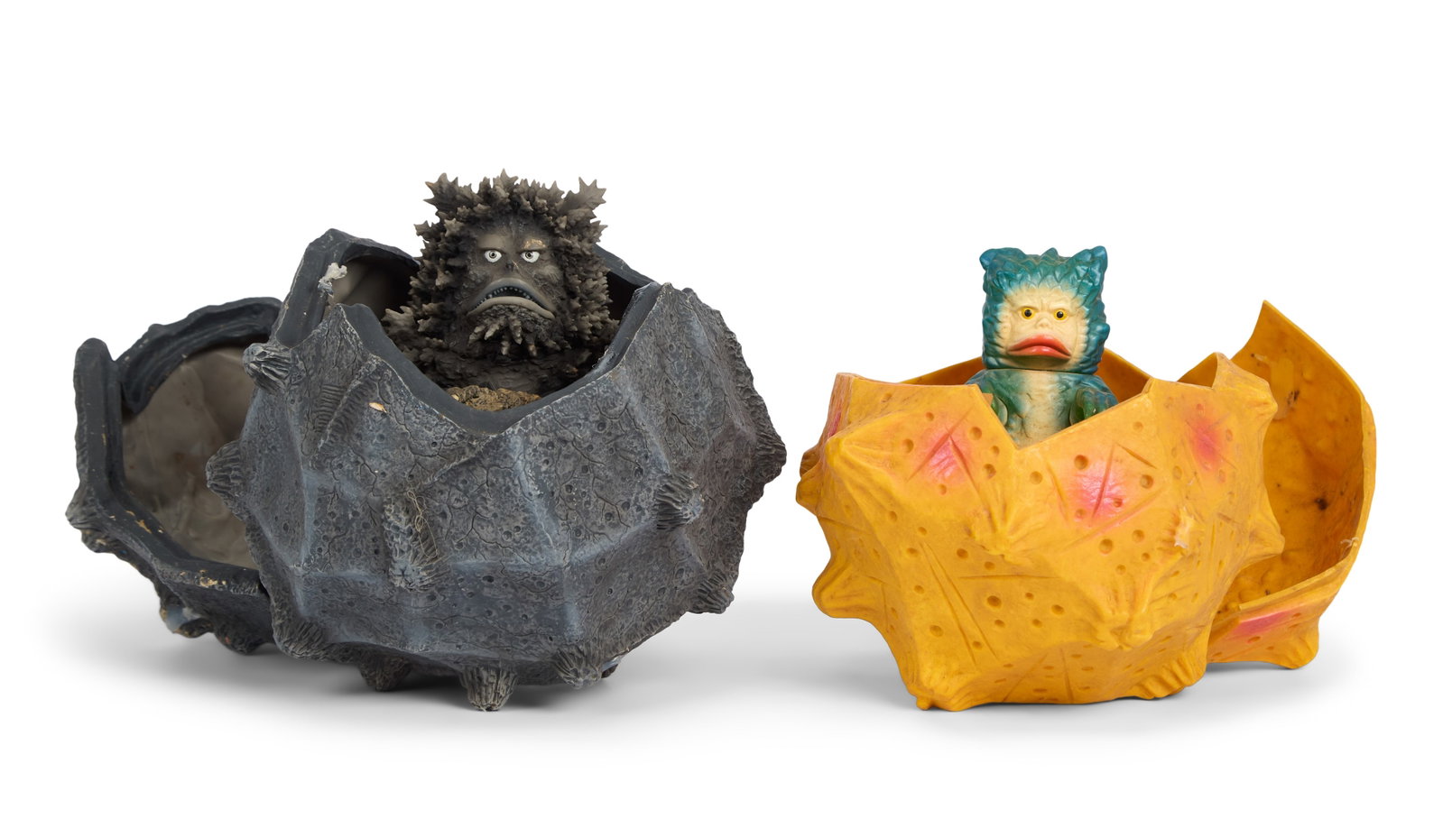 Sofubi | Garamon with Meteorite Figures (2): A group of two Garamon figures with accompanying meteorite figures. One set is an X-Plus Monochrome Project Garamon 2 with Garadama. The other set includes a vintage Tsuburaya Garamon figure and a