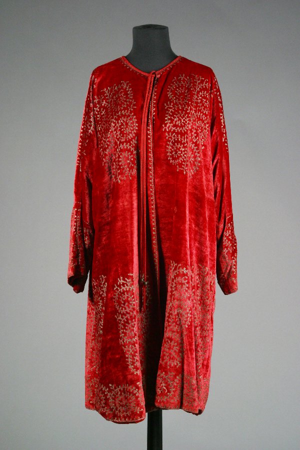 Barbra Streisand Fortuny Velvet Jacket: Custom Burgundy Velvet Jacket Custom burgundy velvet below the knee jacket, having incised in leaf design at top, bottom, and sleeve areas, lace closure at front, no collar, bottom hem weighted at fro