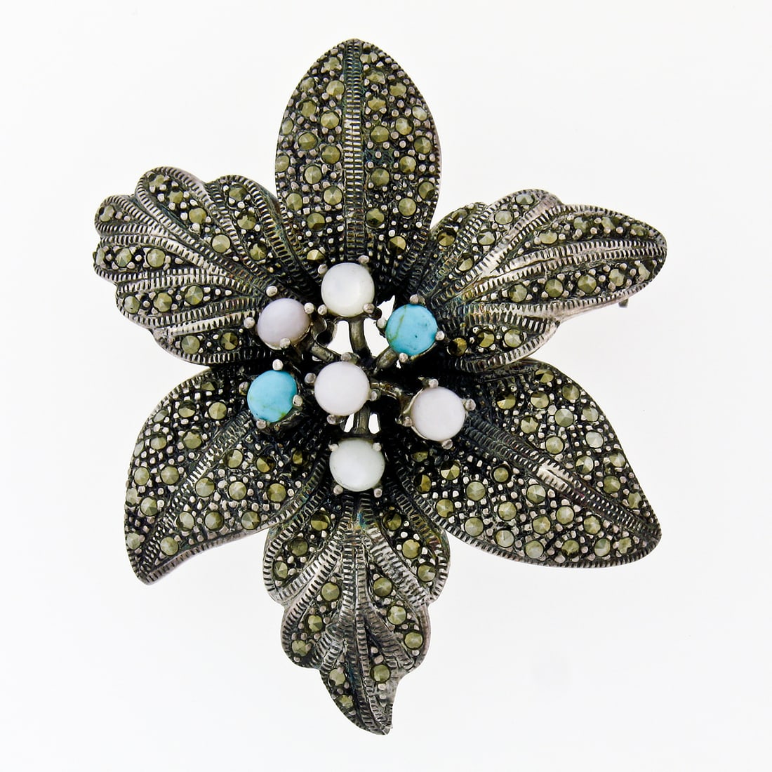 Sterling Silver Flower Brooch with Turquoise Moonstone and Mother of Pearl: Sterling Silver Flower Brooch with Turquoise Moonstone and Mother of Pearl This exquisite brooch pin showcases a stunning flower design crafted from solid 925 sterling silver. The centerpiece features