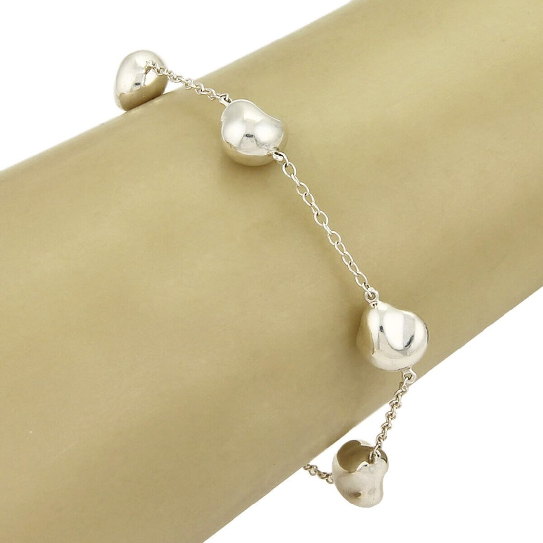 Tiffany & Co. Peretti Sterling Silver Charm Bracelet with 5 Nugget Charms: Tiffany & Co. Peretti Sterling Silver Charm Bracelet with 5 Nugget Charms Elevate your jewelry collection with the Tiffany & Co. Peretti Sterling Silver 5 Nugget Charm Bracelet. This exquisite bracele