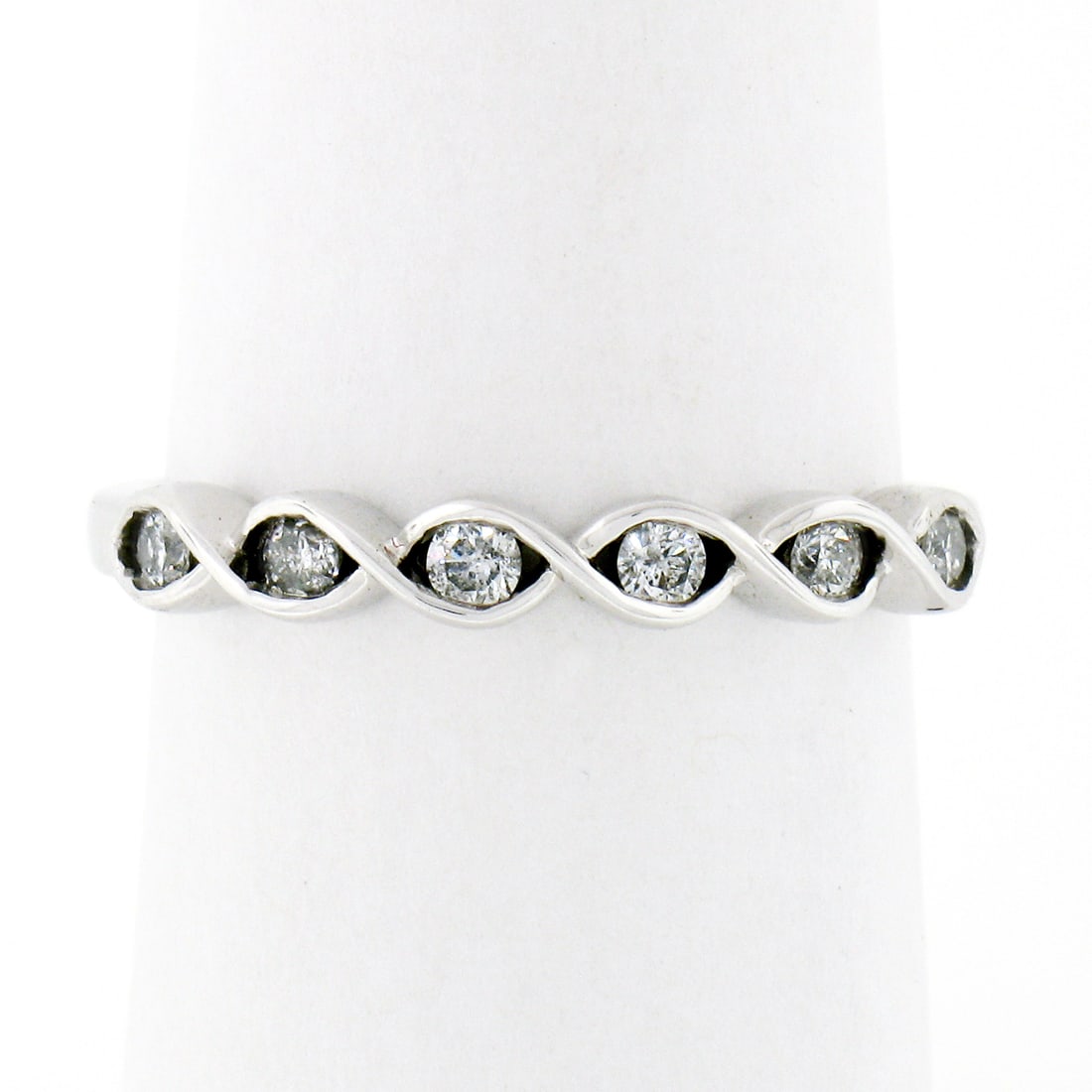 10k White Gold 0.20ctw Round Diamond Stackable Wedding Band Ring: 10k White Gold 0.20ctw Round Diamond Stackable Wedding Band Ring This exquisite stackable wedding band ring features a braided design crafted from solid 10k white gold. It is adorned with 6 natural ro