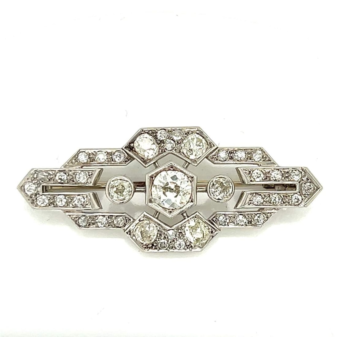 Art Deco Platinum 4.70 Ct Diamond Brooch with 1.20 Ct Center Diamond: Art Deco Platinum 4.70 Ct Diamond Brooch with 1.20 Ct Center Diamond This exquisite Art Deco brooch is crafted from platinum and features a stunning total diamond weight of 4.70 carats. The centerpiec