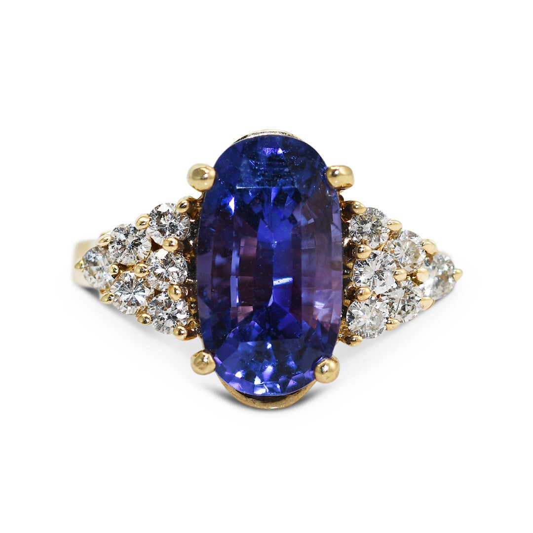 GIA Certified 14k Yellow Gold 4.86ct Sapphire & 0.50ct Diamond Ring: GIA Certified 14k Yellow Gold 4.86ct Sapphire & 0.50ct Diamond Ring This stunning ring features a captivating oval violet-blue sapphire weighing 4.86 carats, beautifully set in a 14k yellow gold band.