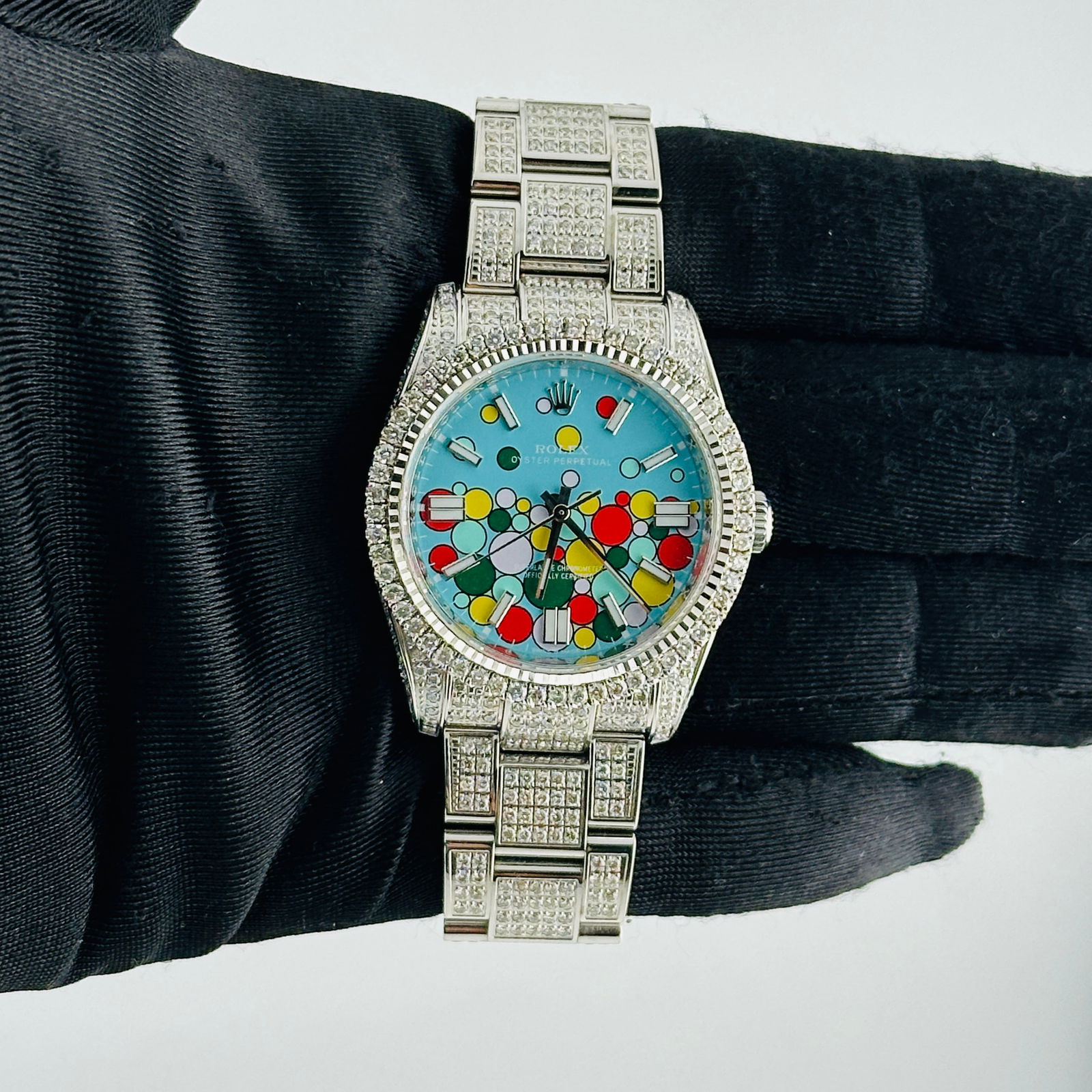 Rolex Oyster Perpetual 116000 Aftermarket Celebration Dial Iced Out Bracelet: Rolex Oyster Perpetual 116000 Aftermarket Celebration Dial Iced Out Bracelet Experience the elegance of the Rolex Oyster Perpetual featuring a stunning After Market green dial. This men's watch boasts