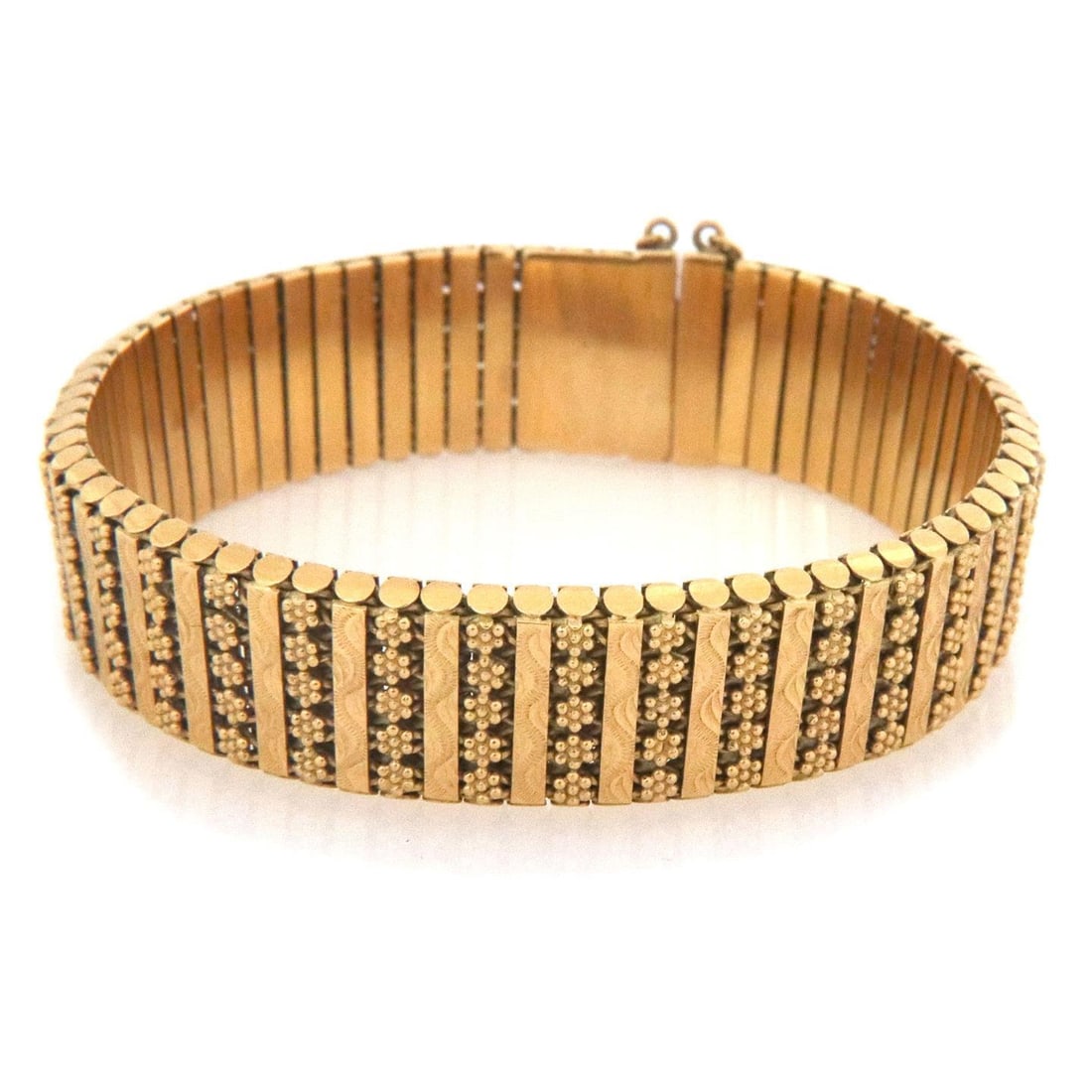 Etruscan Byzantine 19k Yellow Gold Flex Bracelet with Safety Chain: Etruscan Byzantine 19k Yellow Gold Flex Bracelet with Safety Chain This exquisite Etruscan Byzantine bracelet is crafted from 19k yellow gold, featuring a polished interior and a striking front adorne