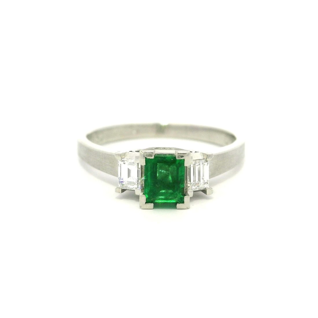 Platinum Cocktail Ring 0.81ct Emerald and Diamond 3 Stone Design: Platinum Cocktail Ring 0.81ct Emerald and Diamond 3 Stone Design This exquisite cocktail ring features a stunning natural emerald at the center, beautifully complemented by two natural diamonds. The e
