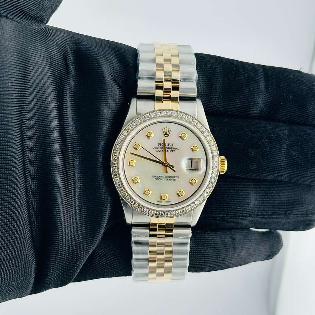 Rolex Datejust 1601 Men's White MOP Diamond Dial Jubilee Bracelet: Rolex Datejust 1601 Men's White MOP Diamond Dial Jubilee Bracelet This Rolex Datejust features a striking Aftermarket White Mother of Pearl (MOP) diamond dial complemented by a stunning pave 10K diamo
