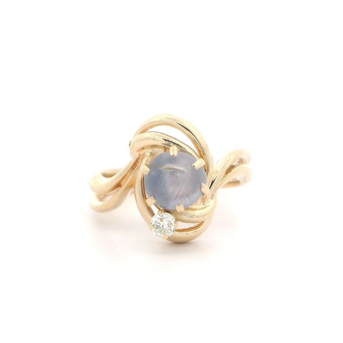 14k Yellow Gold Star Sapphire Diamond Cocktail Swirl Ring: 14k Yellow Gold Star Sapphire Diamond Cocktail Swirl Ring This elegant cocktail ring showcases a stunning round star sapphire and diamond set in polished open work swirl design. The centerpiece is a n