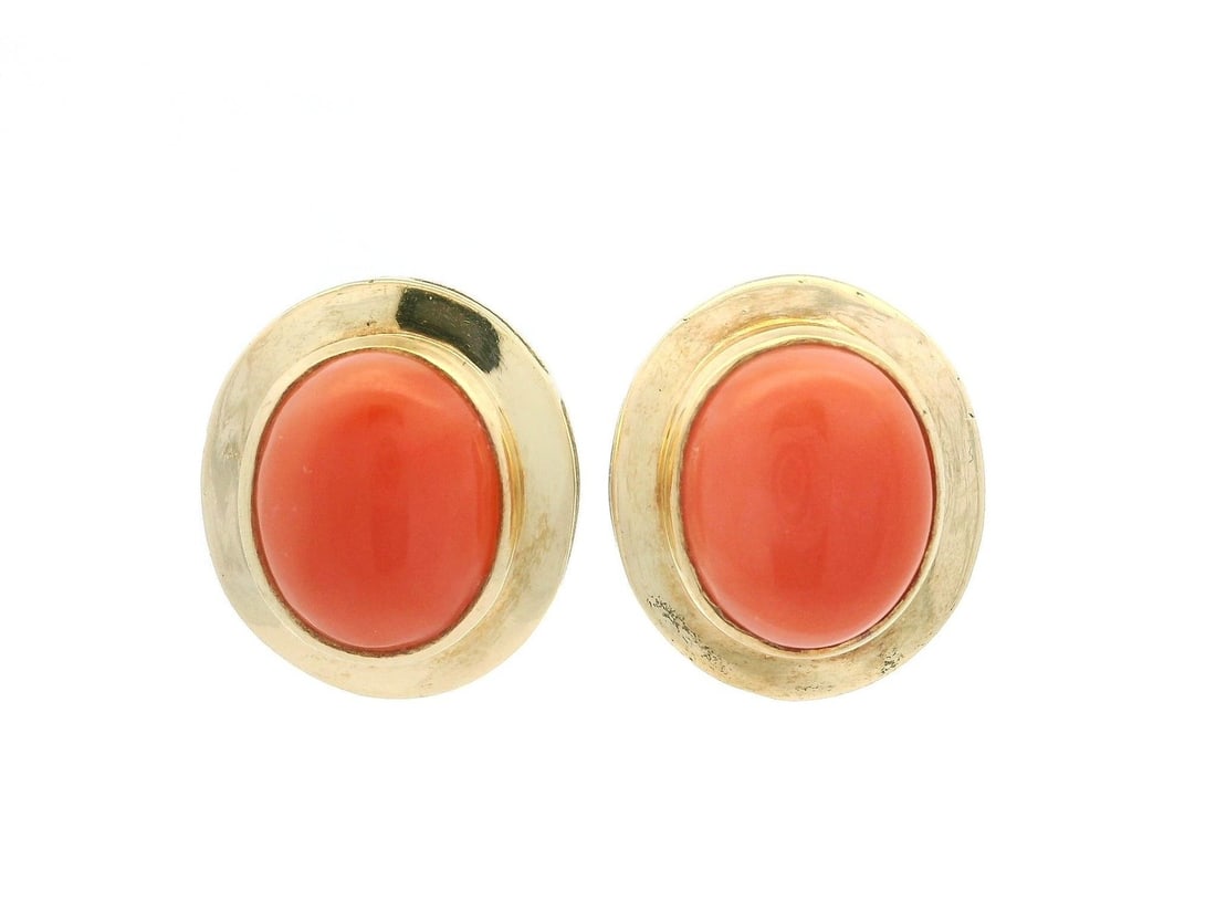 Yellow Gold Salmon Coral Oval Cabochon Stud Earrings 18k: Yellow Gold Salmon Coral Oval Cabochon Stud Earrings 18k These stunning stud earrings feature a classic design crafted with natural salmon coral stones. Each earring showcases an oval cabochon cut cor