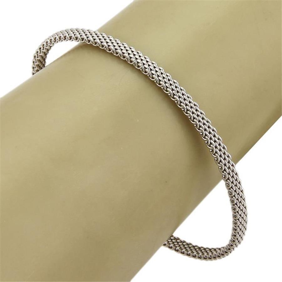 Tiffany & Co. Somerset 18k White Gold Mesh Bangle Bracelet: Tiffany & Co. Somerset 18k White Gold Mesh Bangle Bracelet Introducing the Tiffany & Co. Somerset Bracelet, a stunning piece from the esteemed Somerset collection. Crafted from luxurious 18k white gol