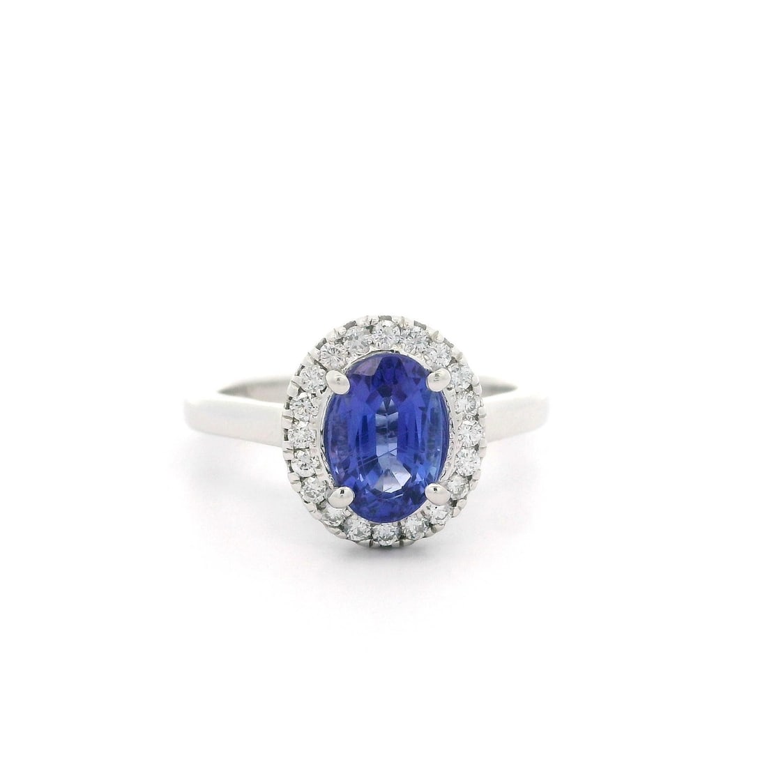 Elegant 14k White Gold 1.58ctw Oval Tanzanite Diamond Halo Ring: Elegant 14k White Gold 1.58ctw Oval Tanzanite Diamond Halo Ring This exquisite cocktail ring showcases a stunning 1.58 carat total weight of genuine gemstones, featuring a natural oval-cut violet blue