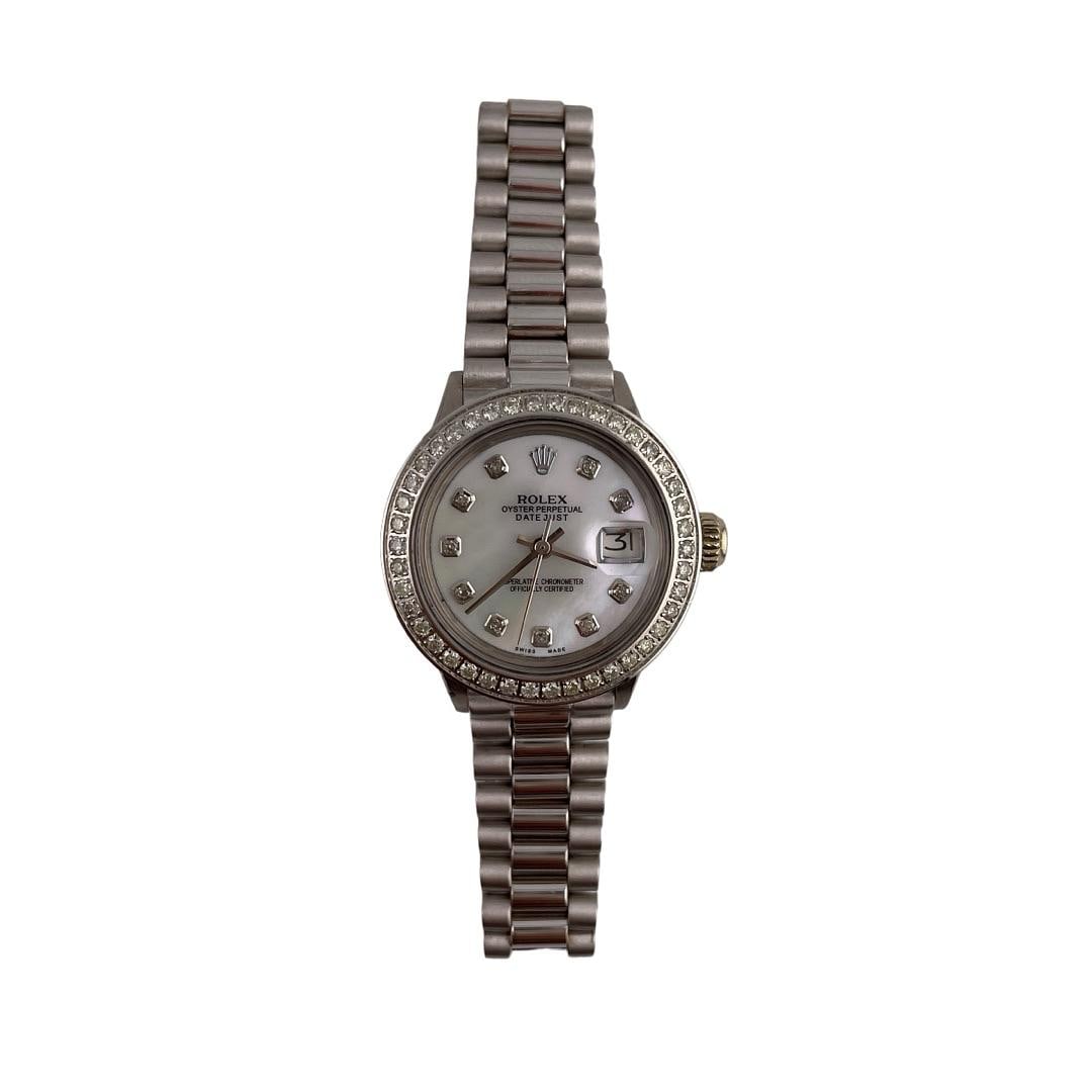 Rolex Datejust Ladies 6527 White MOP Diamond Bezel After Market President Bracelet: Rolex Datejust Ladies 6527 White MOP Diamond Bezel After Market President Bracelet This exquisite Rolex Datejust features a stunning After Market White Mother of Pearl dial, elegantly framed by a diam