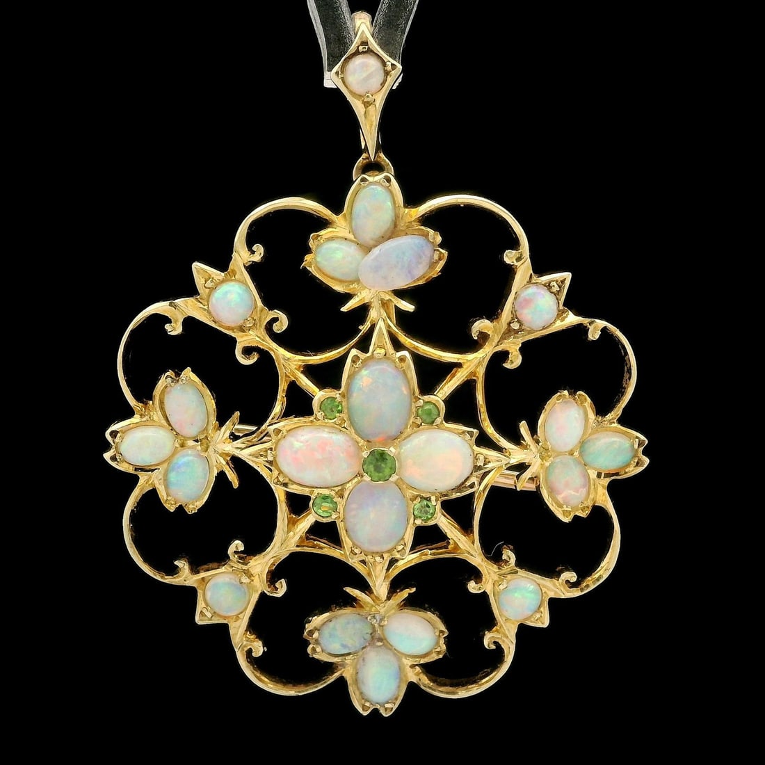 Vintage Floral Brooch Pendant in Yellow Gold with Opal and Green Garnet: Vintage Floral Brooch Pendant in Yellow Gold with Opal and Green Garnet This stunning vintage brooch pendant features a floral open work design crafted in solid 12-14K yellow gold. Adorned with 20 nat