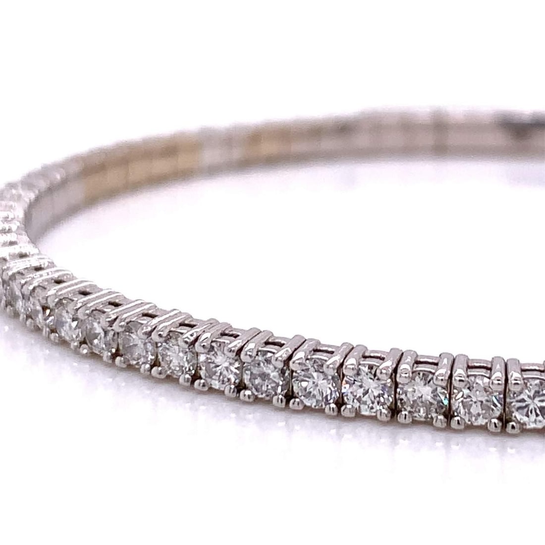 14K White Gold 5.70 Ct Diamond Bangle with 67 Diamonds: 14K White Gold 5.70 Ct Diamond Bangle with 67 Diamonds This exquisite bangle is crafted from 14K white gold and features a stunning array of 67 round diamonds, with a total weight of approximately 5.7