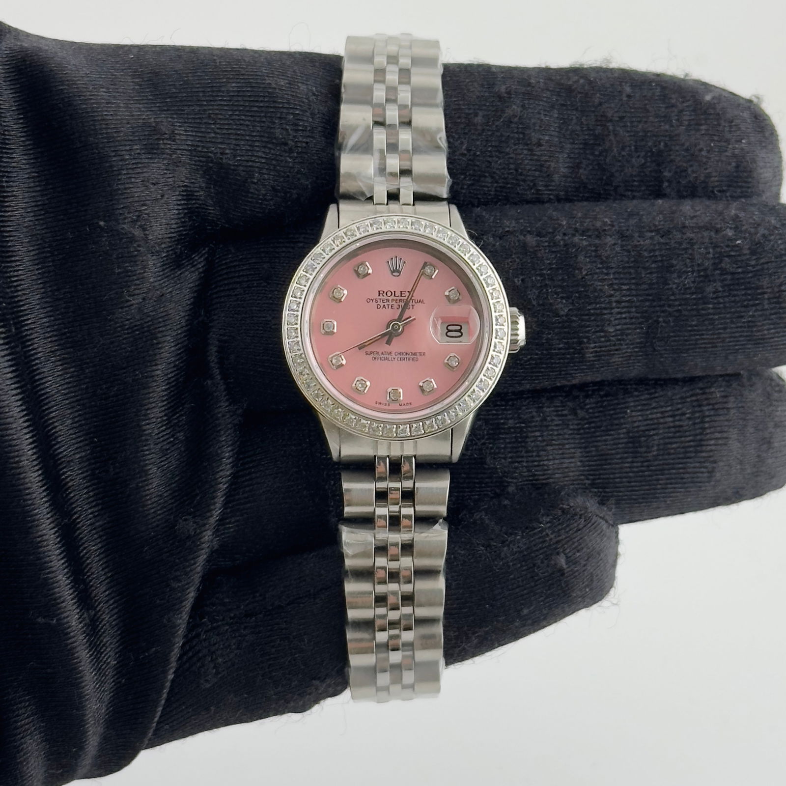 Ladies Datejust Ref 6517 Watch Pink Diamond Dial Aftermarket Jubilee: Ladies Datejust Ref 6517 Watch Pink Diamond Dial Aftermarket Jubilee This ladies' Rolex Datejust features an aftermarket pink diamond dial and a pave diamond bezel. The watch is equipped with an after