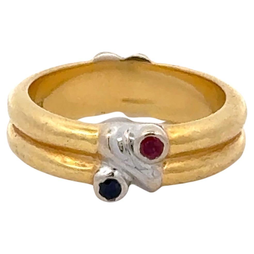 Tiffany & Co 18K Yellow Gold Ruby Sapphire X Band Ring Italy 1990s: Tiffany & Co 18K Yellow Gold Ruby Sapphire X Band Ring Italy 1990s This exquisite Tiffany & Co. band ring is crafted from 18 karat yellow gold, featuring a contemporary 'X' design adorned with round-c