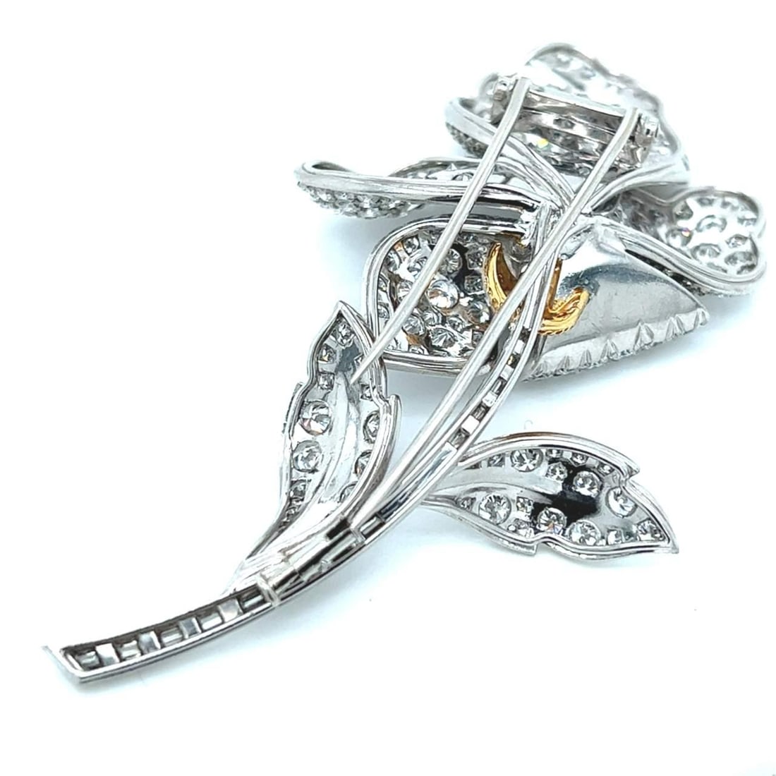 Platinum Flower Brooch with 2.81 Ct Emerald and 17.55 Ct Diamonds: Platinum Flower Brooch with 2.81 Ct Emerald and 17.55 Ct Diamonds This stunning Platinum Emerald & Diamond Flower Brooch showcases a vibrant 2.81 Ct. emerald at its center, surrounded by numerous spar