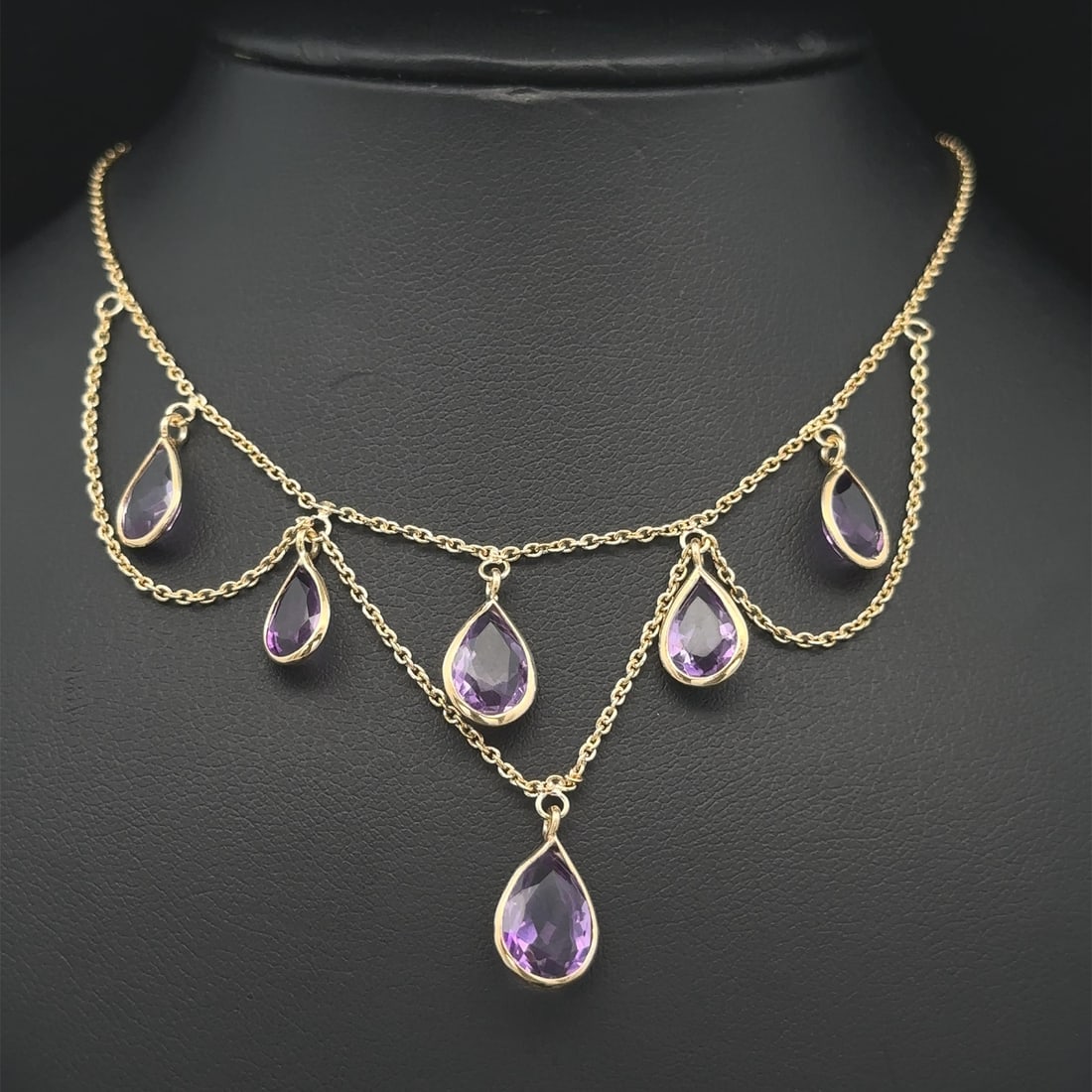 14k Yellow Gold Amethyst Teardrop Chandelier Necklace 16.5 in: 14k Yellow Gold Amethyst Teardrop Chandelier Necklace 16.5 in This stunning necklace features a beautiful arrangement of six natural genuine amethyst stones, each elegantly cut in a teardrop pear shap