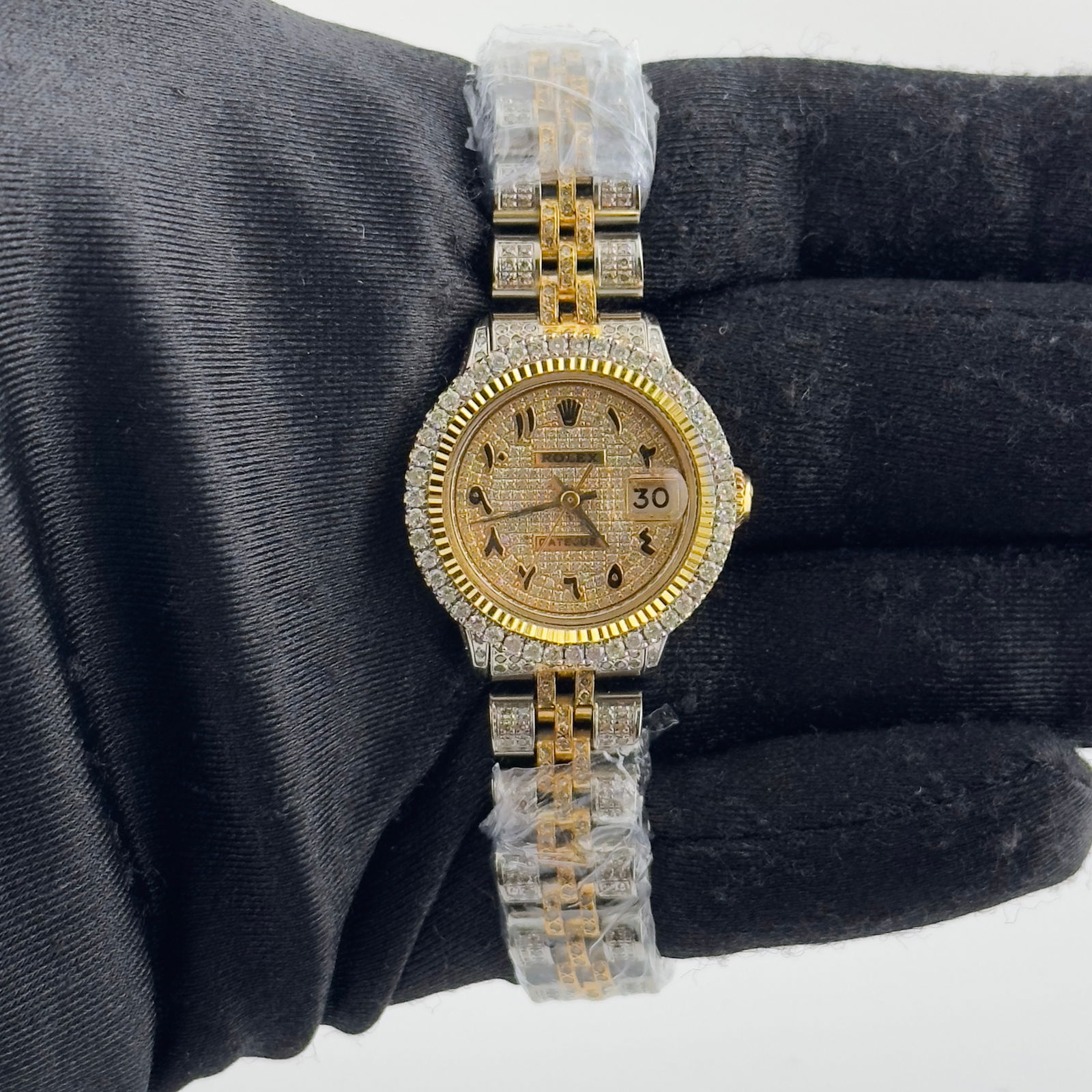 Ladies Aftermarket Datejust 6524 with Iced Out Arabic Dial and Jubilee Bracelet: Ladies Aftermarket Datejust 6524 with Iced Out Arabic Dial and Jubilee Bracelet This ladies Rolex Datejust features an iced out Arabic dial and a prong plated bezel. The watch is equipped with an afte