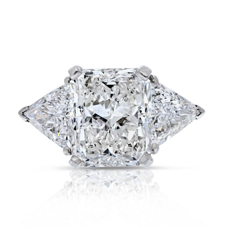5.56 Carat GIA Radiant Cut Three Stone Engagement Ring in 18K White Gold: 5.56 Carat GIA Radiant Cut Three Stone Engagement Ring in 18K White Gold This stunning engagement ring features a breathtaking 5.56 carat radiant cut diamond, certified by GIA, boasting a G color and