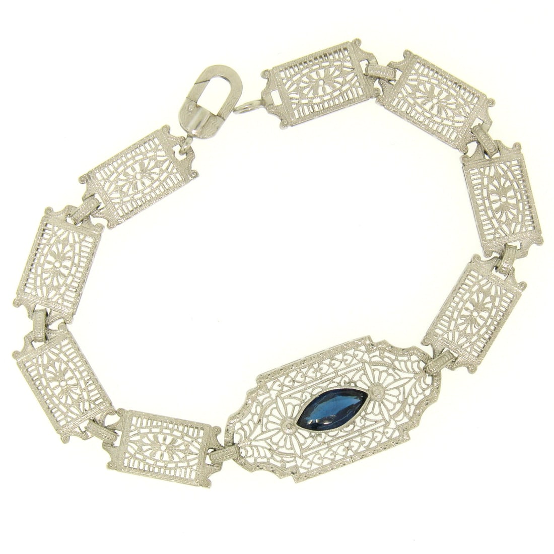Edwardian 10k White Gold Filigree Bracelet with Marquise Simulated Sapphire: Edwardian 10k White Gold Filigree Bracelet with Marquise Simulated Sapphire Discover the elegance of this Antique Edwardian bracelet, meticulously handcrafted from solid 10k white gold. This exquisite