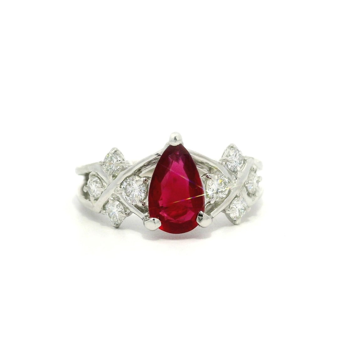 Platinum GIA Certified 1.45ct Vivid Red Ruby Pear Ring with Diamonds: Platinum GIA Certified 1.45ct Vivid Red Ruby Pear Ring with Diamonds Presenting a stunning cocktail ring crafted in solid .900 platinum, featuring a captivating natural vivid red ruby and sparkling di