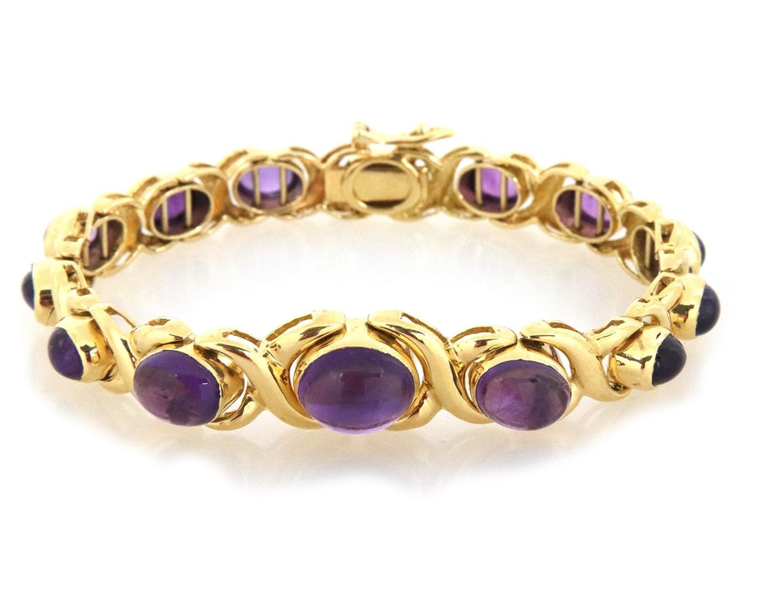 Elegant 18k Yellow Gold Amethyst Cabochon Bracelet 25 Carats: Elegant 18k Yellow Gold Amethyst Cabochon Bracelet 25 Carats This stunning bracelet features a polished finish crafted from 18k yellow gold, showcasing an elegant design of graduated oval and X links