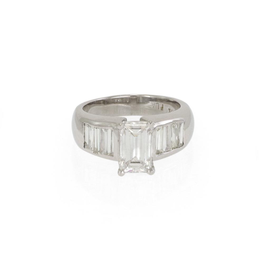 Elegant 2.75 Carat Diamond Platinum Emerald Cut Ring with Baguette Diamonds: Elegant 2.75 Carat Diamond Platinum Emerald Cut Ring with Baguette Diamonds This exquisite diamond engagement ring showcases a stunning emerald cut diamond at its center, securely held in four prongs.