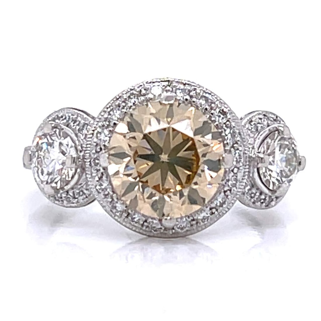 GIA Certified 2.06 Ct Fancy Brown-Yellow Diamond Platinum Ring: GIA Certified 2.06 Ct Fancy Brown-Yellow Diamond Platinum Ring This stunning platinum ring features a striking 2.06 Ct. GIA Certified diamond at its center, showcasing a natural fancy brown-yellow col