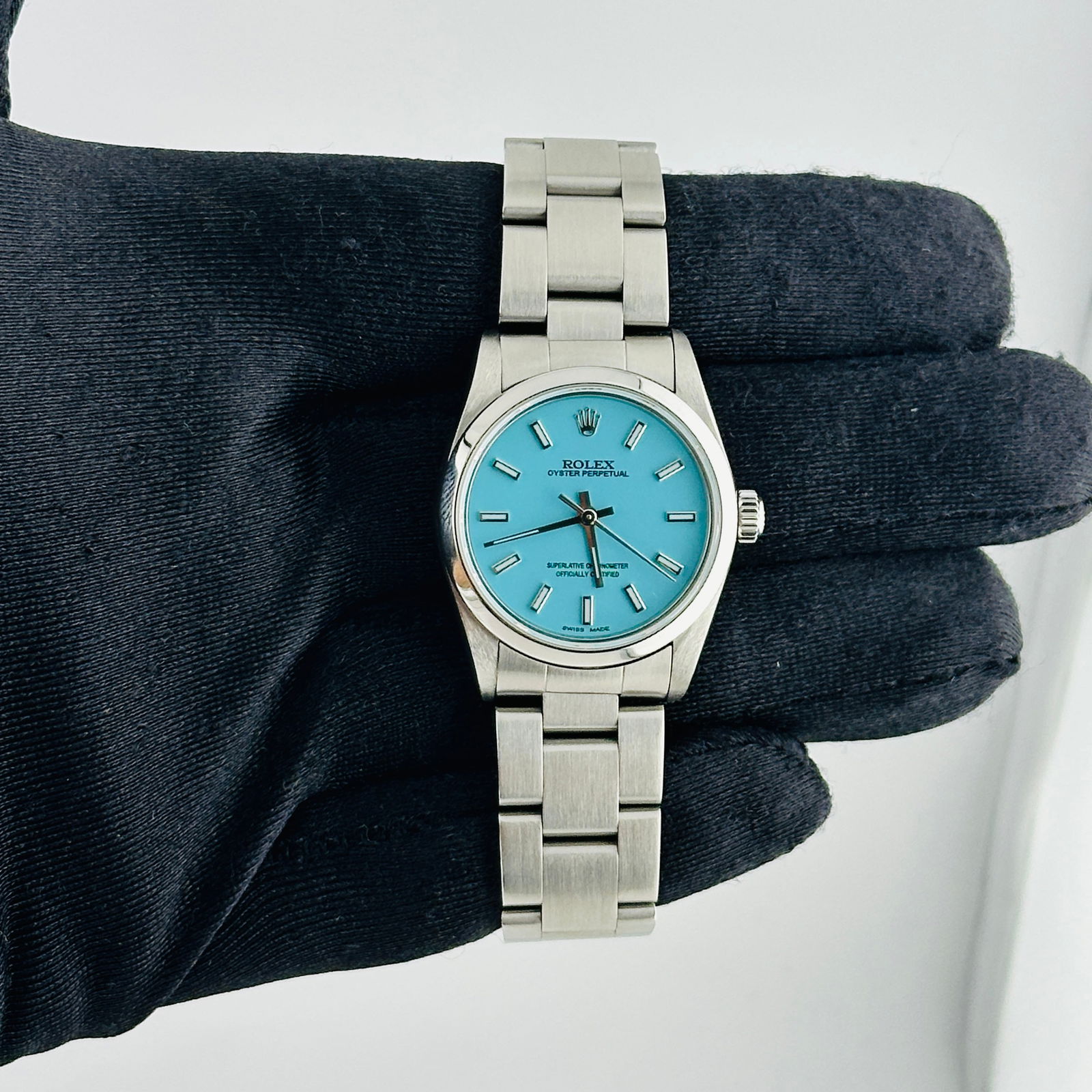 Ladies Oyster Perpetual 77080 With Aftermarket Tiffany Dial On Oyster Bracelet: Ladies Oyster Perpetual 77080 With Aftermarket Tiffany Dial On Oyster Bracelet This is a Rolex Oyster Perpetual wristwatch for ladies, featuring an aftermarket Tiffany dial. It includes a smooth bezel