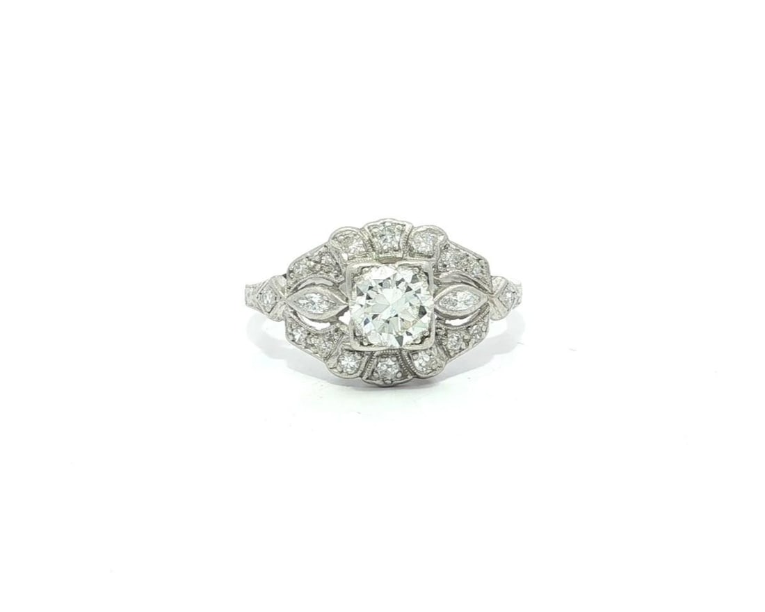 Platinum Art Deco Floral Diamond Engagement Ring with Milgrain Detailing 0.91ctw: Platinum Art Deco Floral Diamond Engagement Ring with Milgrain Detailing 0.91ctw This antique Art Deco engagement ring features a solid platinum setting with intricate milgrain etching and a floral mo