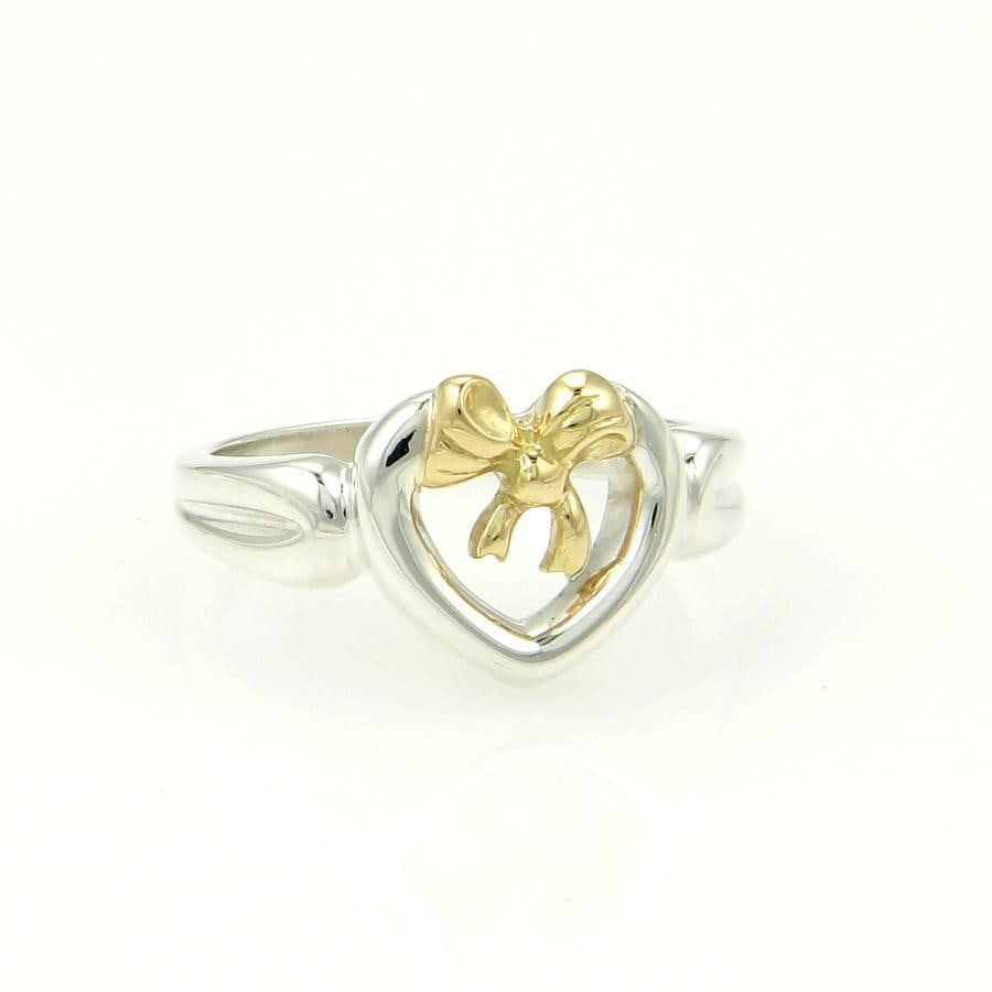 Tiffany & Co Bow Ring Sterling Silver 18k Yellow Gold Heart Design: Tiffany & Co Bow Ring Sterling Silver 18k Yellow Gold Heart Design Discover the elegance of this authentic Tiffany & Co. Bow Ring, a stunning piece crafted from both sterling silver and 18k yellow gol