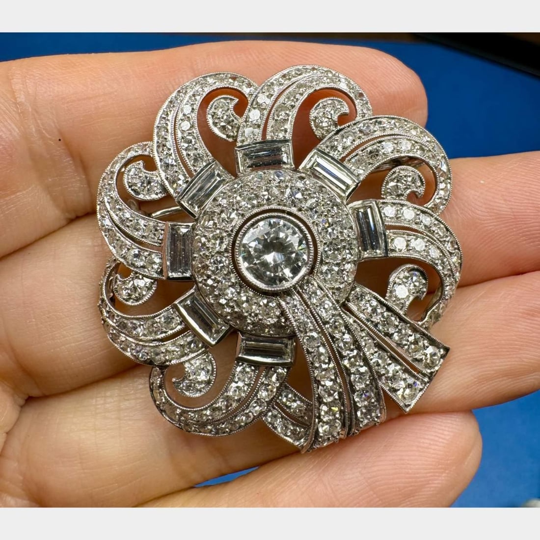 Art Deco Platinum Brooch 7.95 Ct Diamonds H-I VVS Clarity 1.75 inches: Art Deco Platinum Brooch 7.95 Ct Diamonds H-I VVS Clarity 1.75 inches This exquisite Art Deco brooch features a stunning arrangement of diamonds totaling 7.95 carats. Crafted in platinum, the centerpi