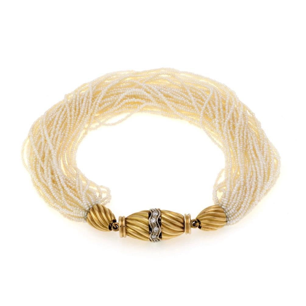 Vintage Multi-Strand Seed Pearls Bracelet 18k Gold Diamonds: Vintage Multi-Strand Seed Pearls Bracelet 18k Gold Diamonds This stunning vintage bracelet showcases a luxurious combination of 18k yellow and white gold, adorned with 42 delicate strands of fine seed