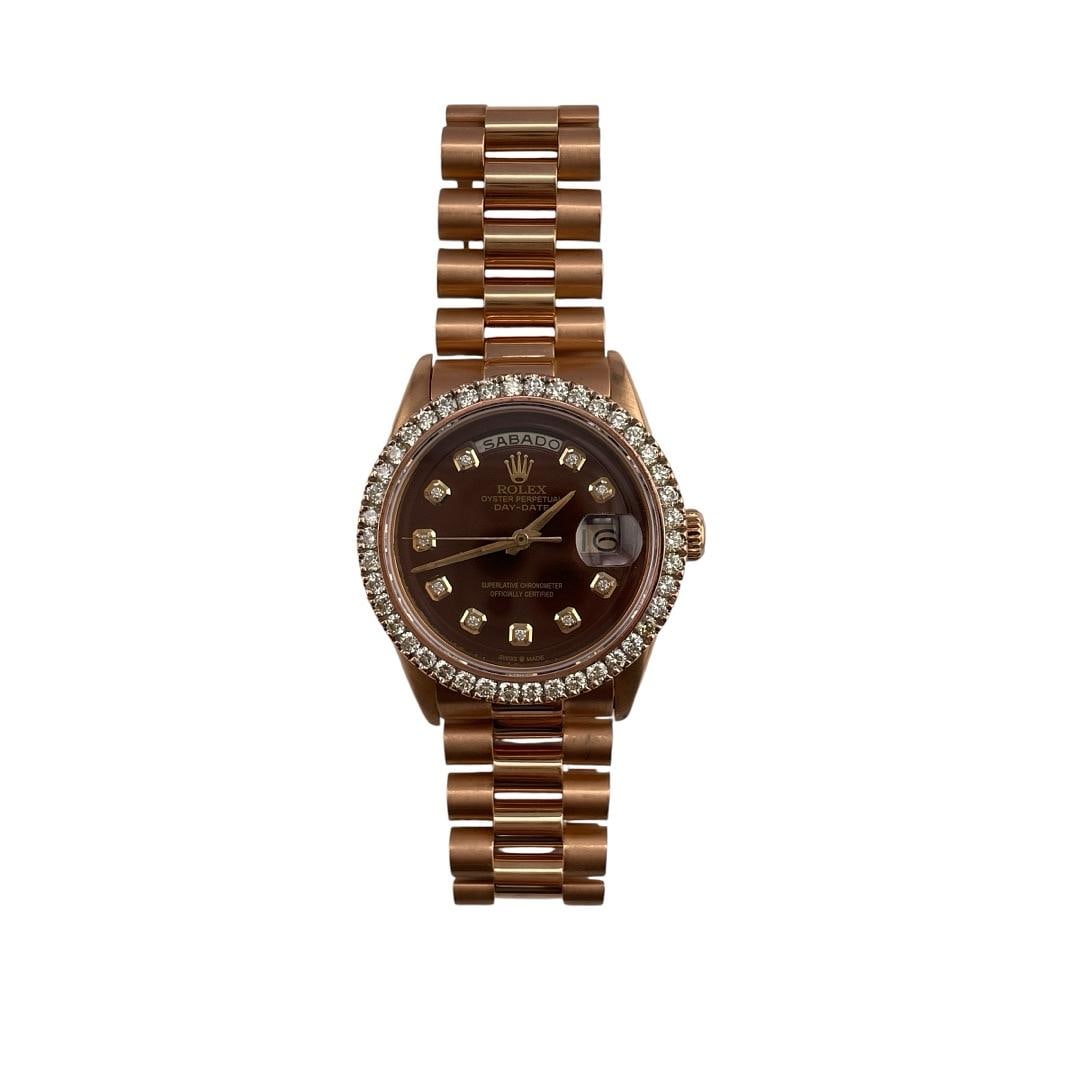 Day-Date Reference 1803 Chocolate Dial with Aftermarket President Bracelet: Day-Date Reference 1803 Chocolate Dial with Aftermarket President Bracelet This Rolex Day-Date features an Aftermarket chocolate dial, complemented by a diamond bezel and an Aftermarket President brac