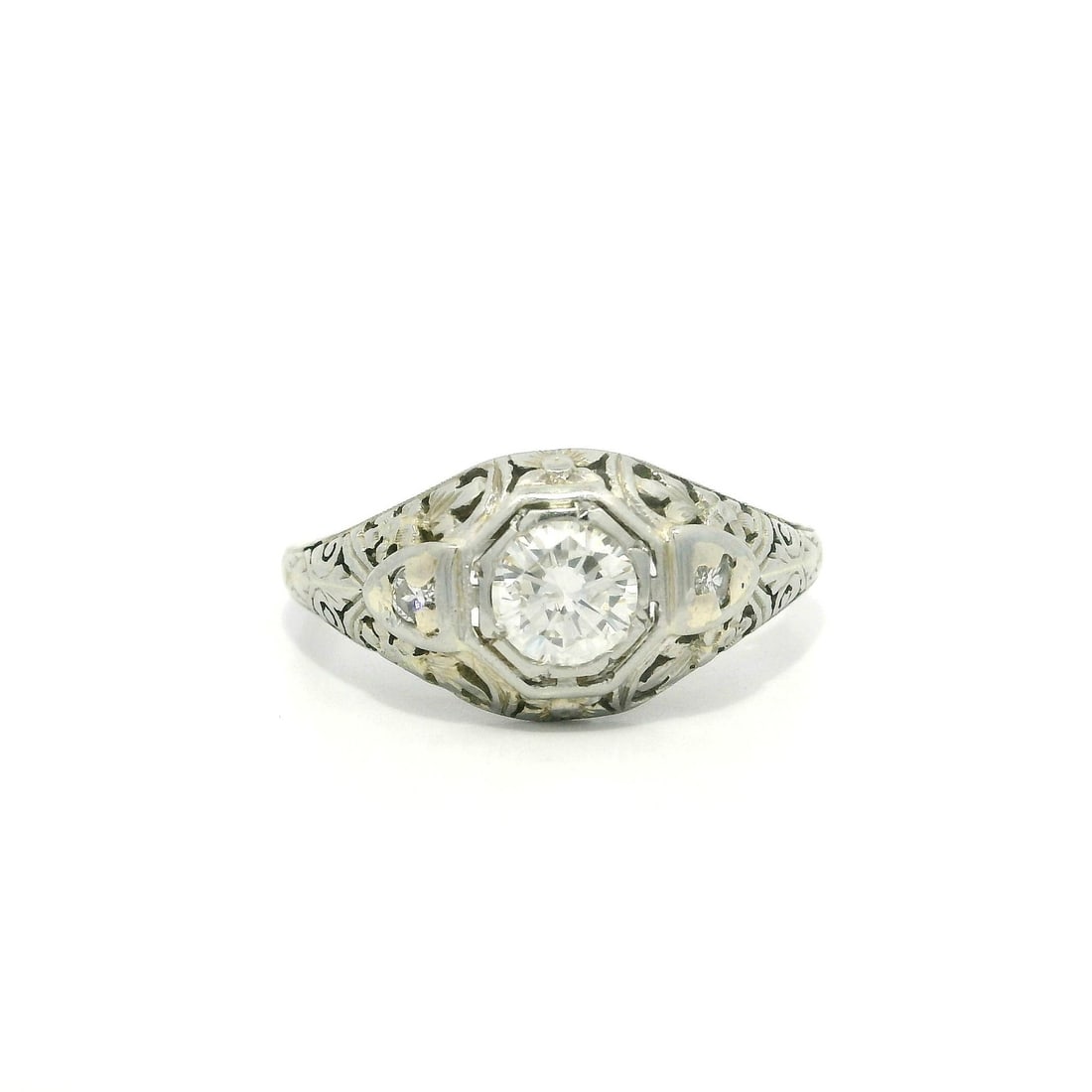 Antique Art Deco 0.53ct Diamond Floral Filigree Engagement Ring in White Gold: Antique Art Deco 0.53ct Diamond Floral Filigree Engagement Ring in White Gold This exquisite antique Art Deco engagement ring features a stunning .53ct diamond centerpiece, elegantly complemented by i